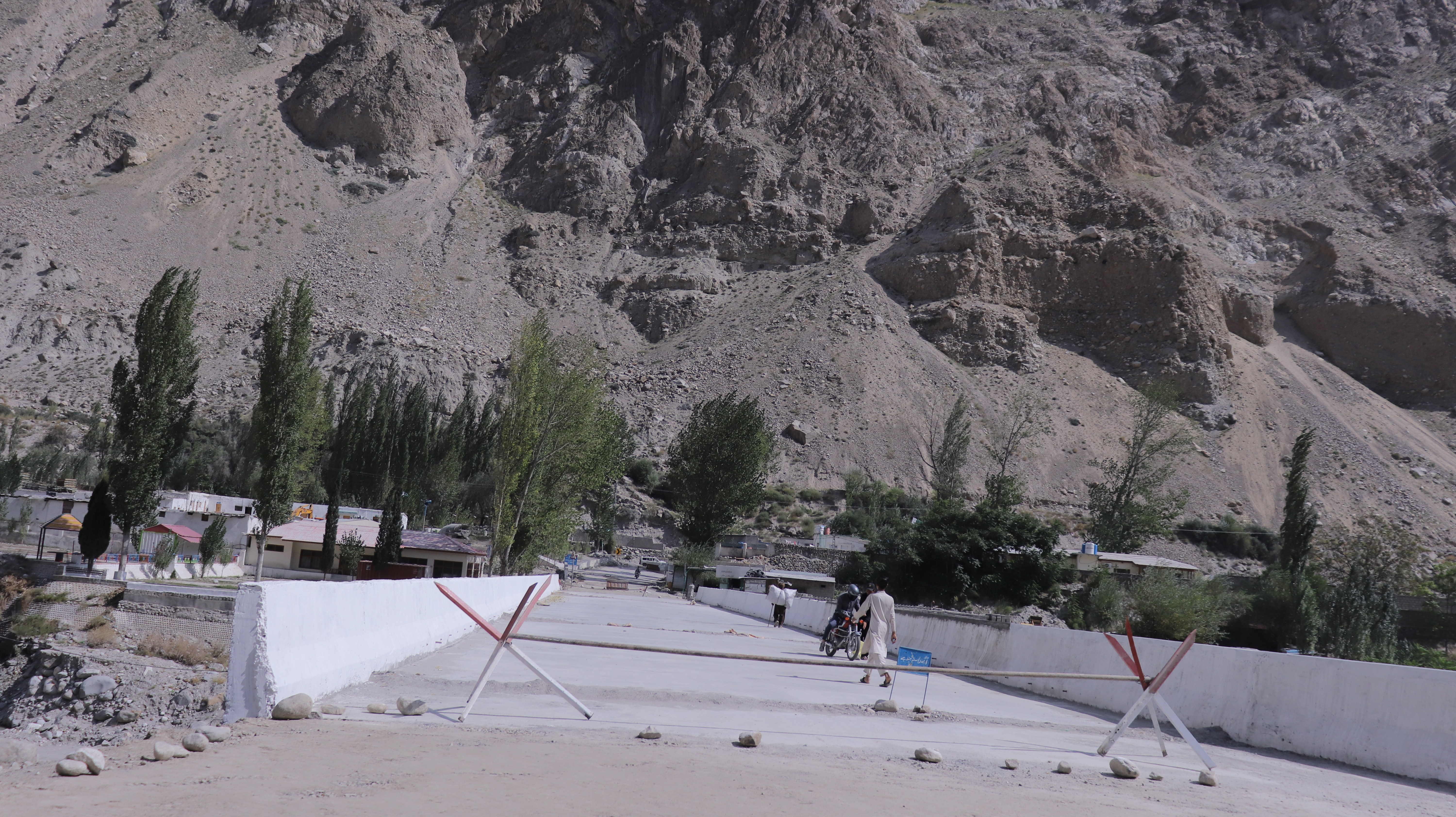 People passing by  temporarily closed Hassanabad bridge under construction in Gilgit Baltistan