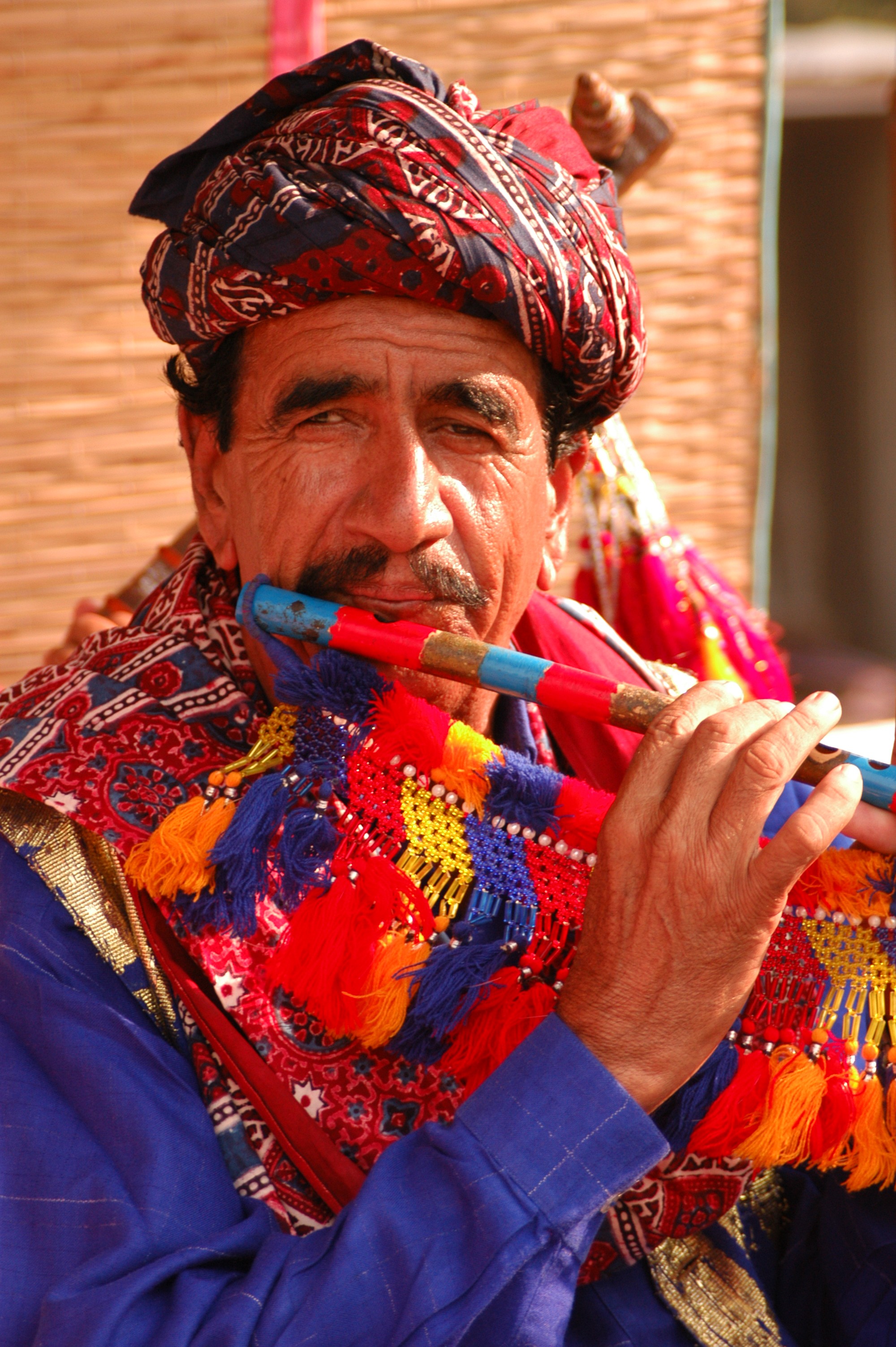 A Sindhi fluet player wearing ajrak turban(a turban with unique form of block-printing found mostly in Sindh, Pakistan)