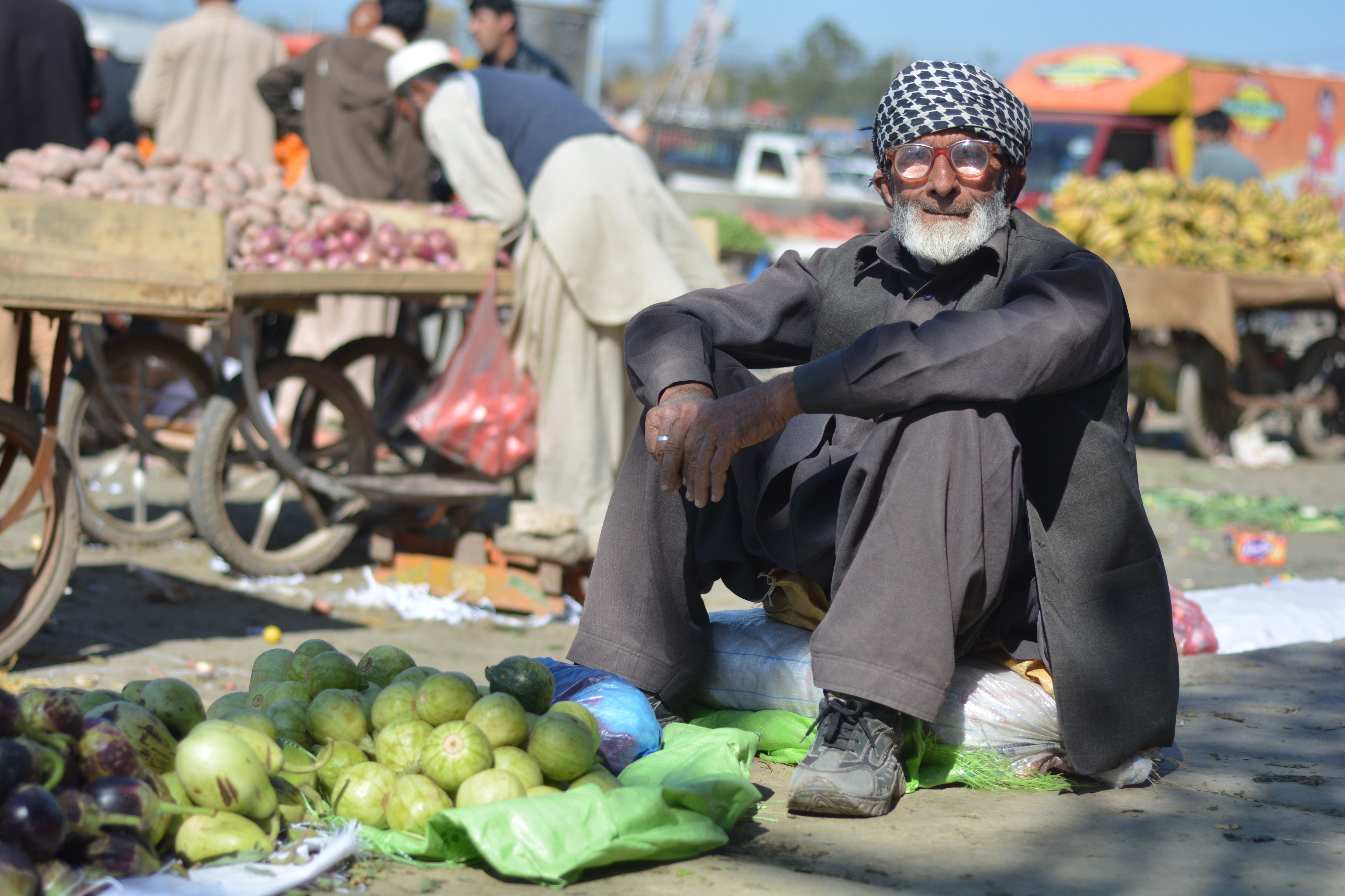 An old man selling vegetables at a road side