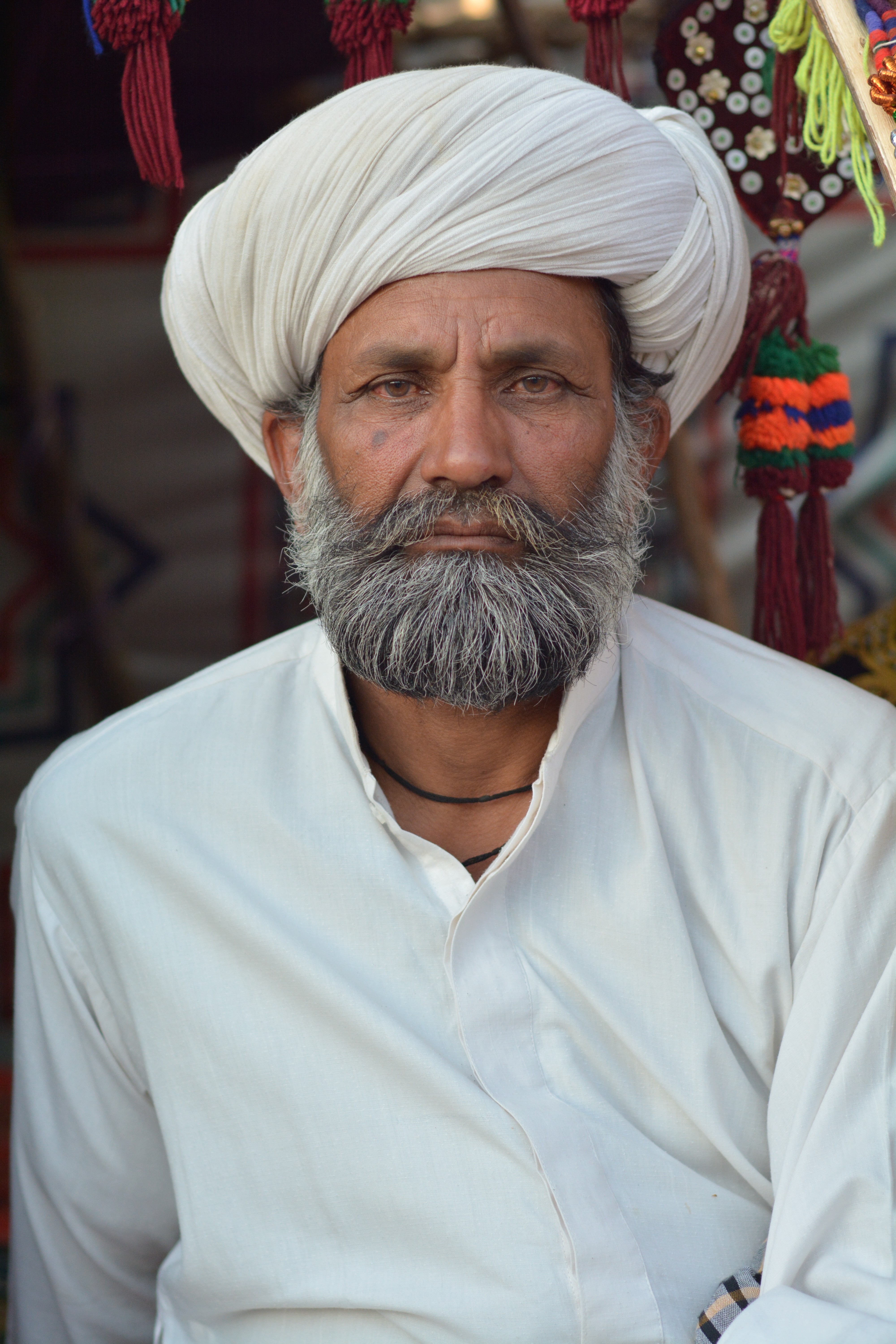 A potrait of an old man wearing local turban