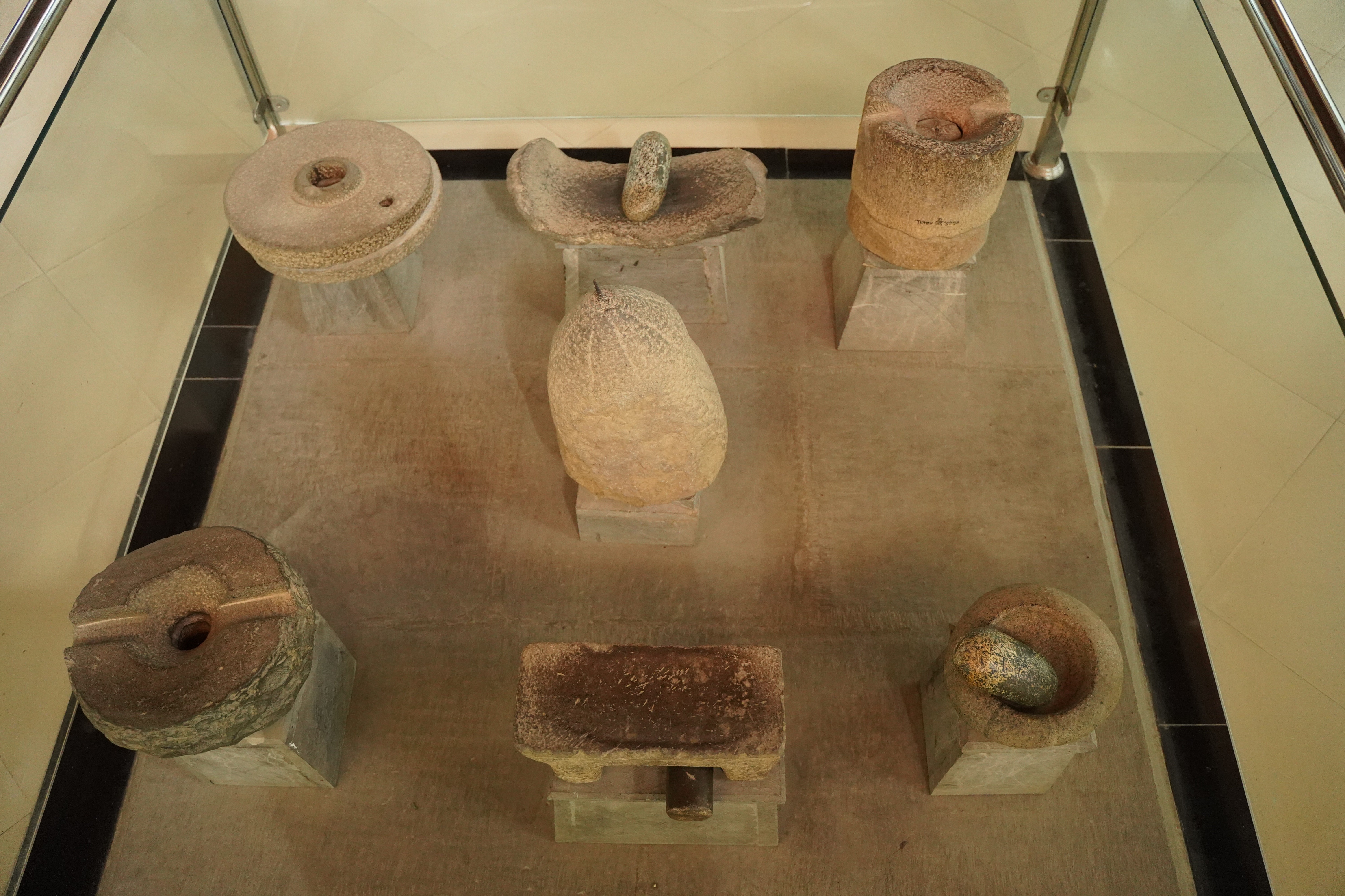 Collection of ancient kitchen accessories including the spice grinder and hand mill