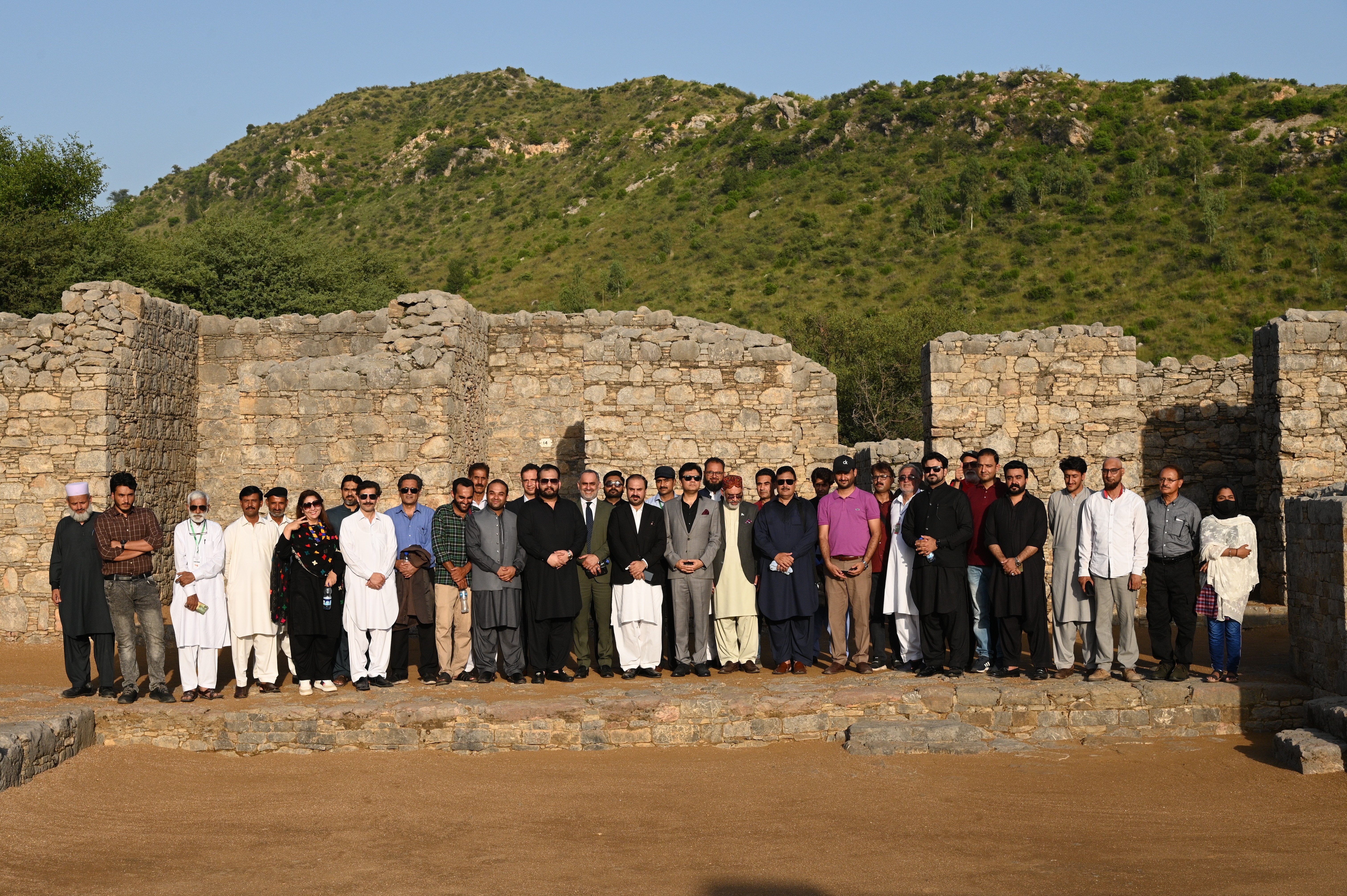 A group photo of tourists with Wasi Shah, a well-known figure in the field of literature in Pakistan and the  caretaker federal minister of tourism Pakistan