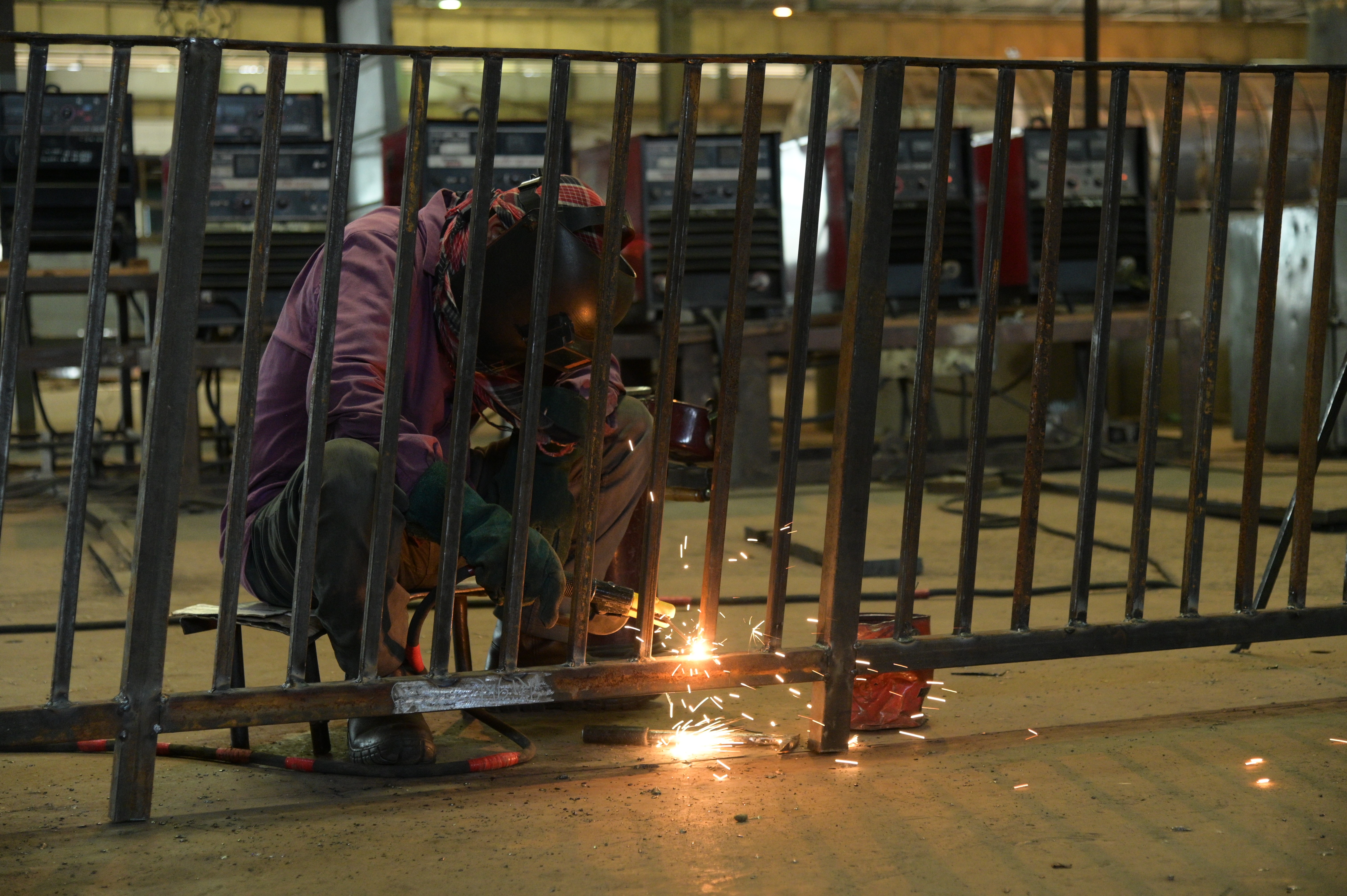 A worker welding the iron bars