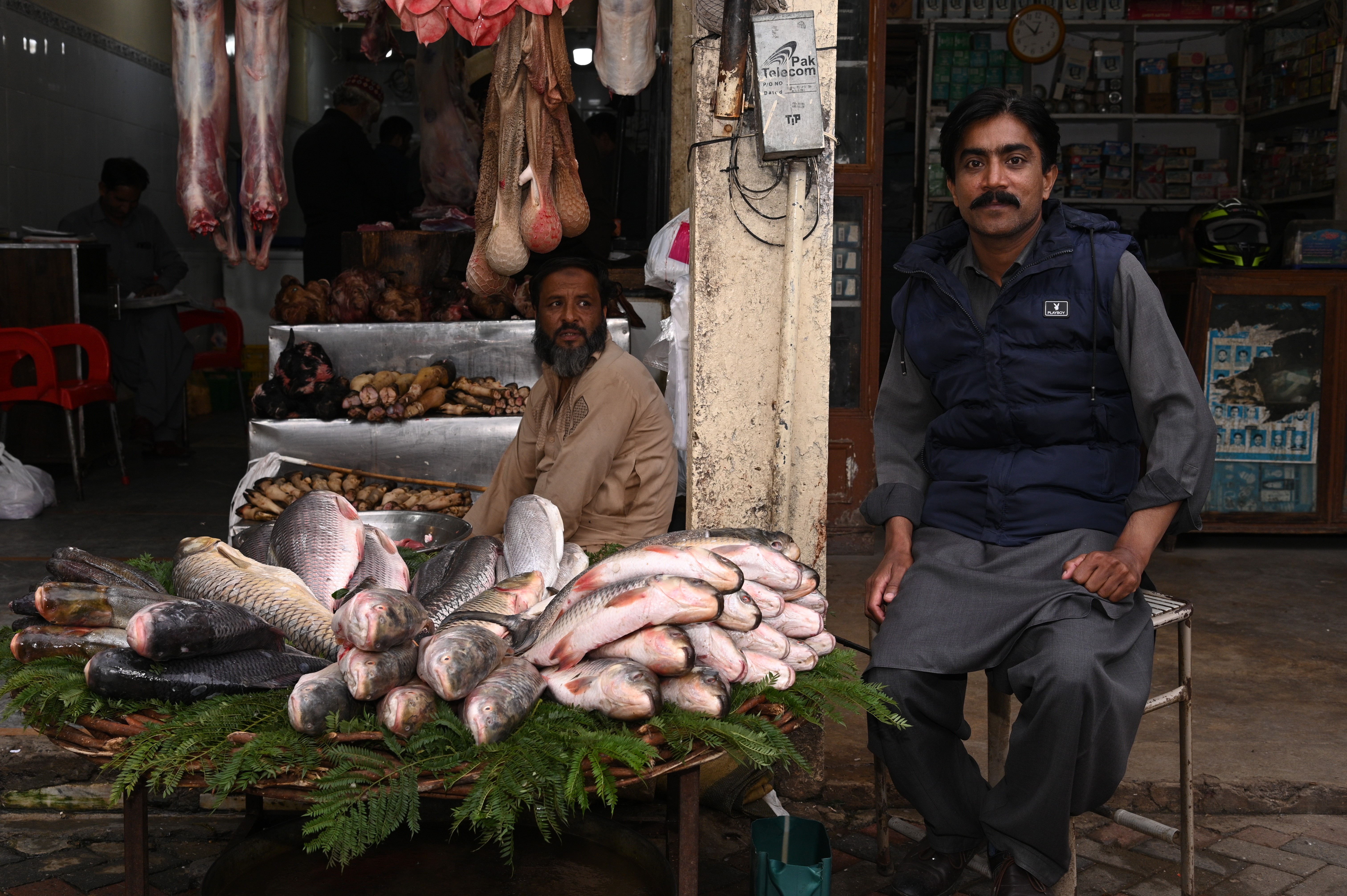 A man selling fish in the fish market in Abpara ahead of winter