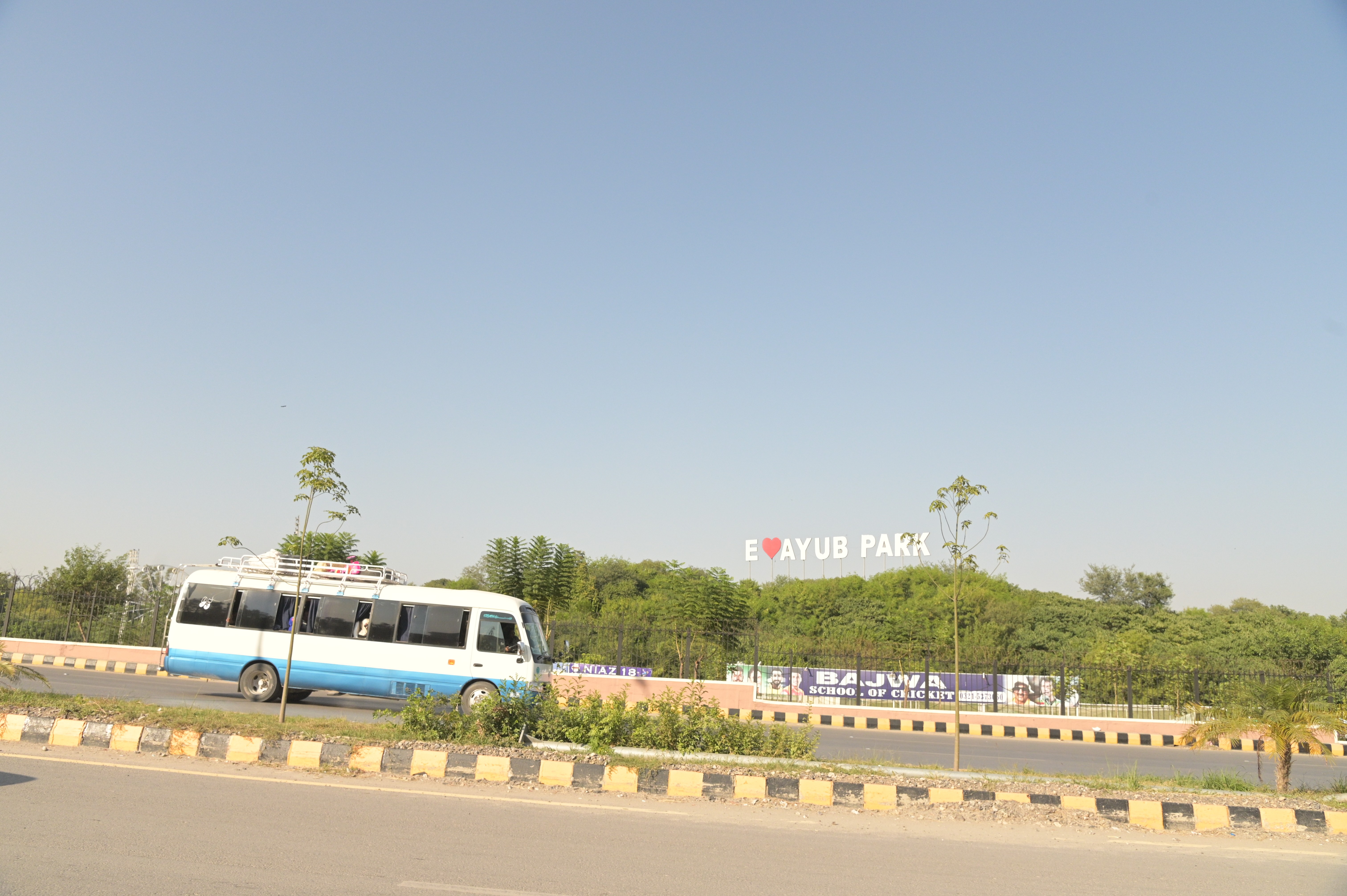 A bus passing by the Ayub Park located on the GT road