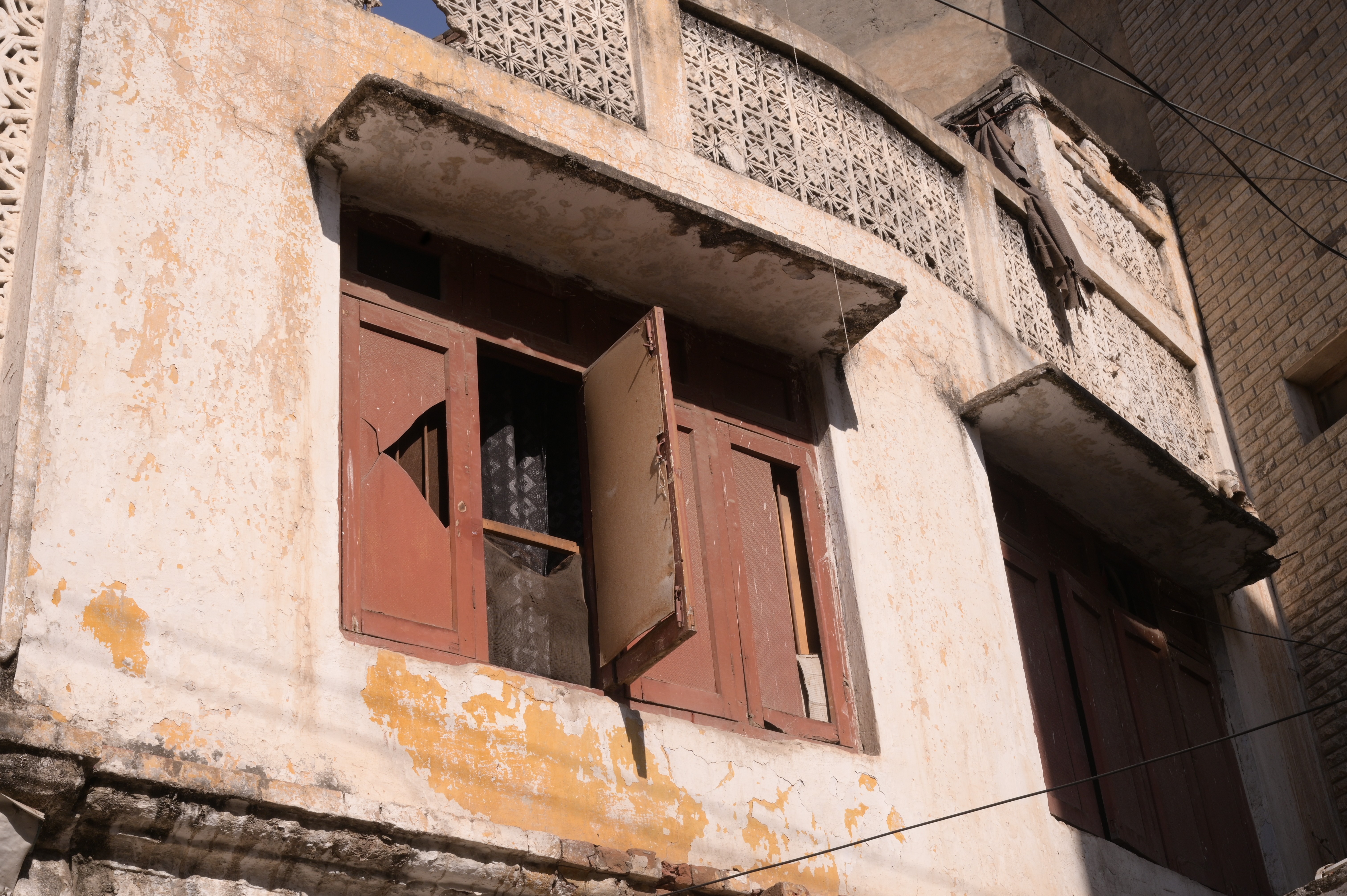 A broken wooden window showing the architectural heritage of Rawalpindi