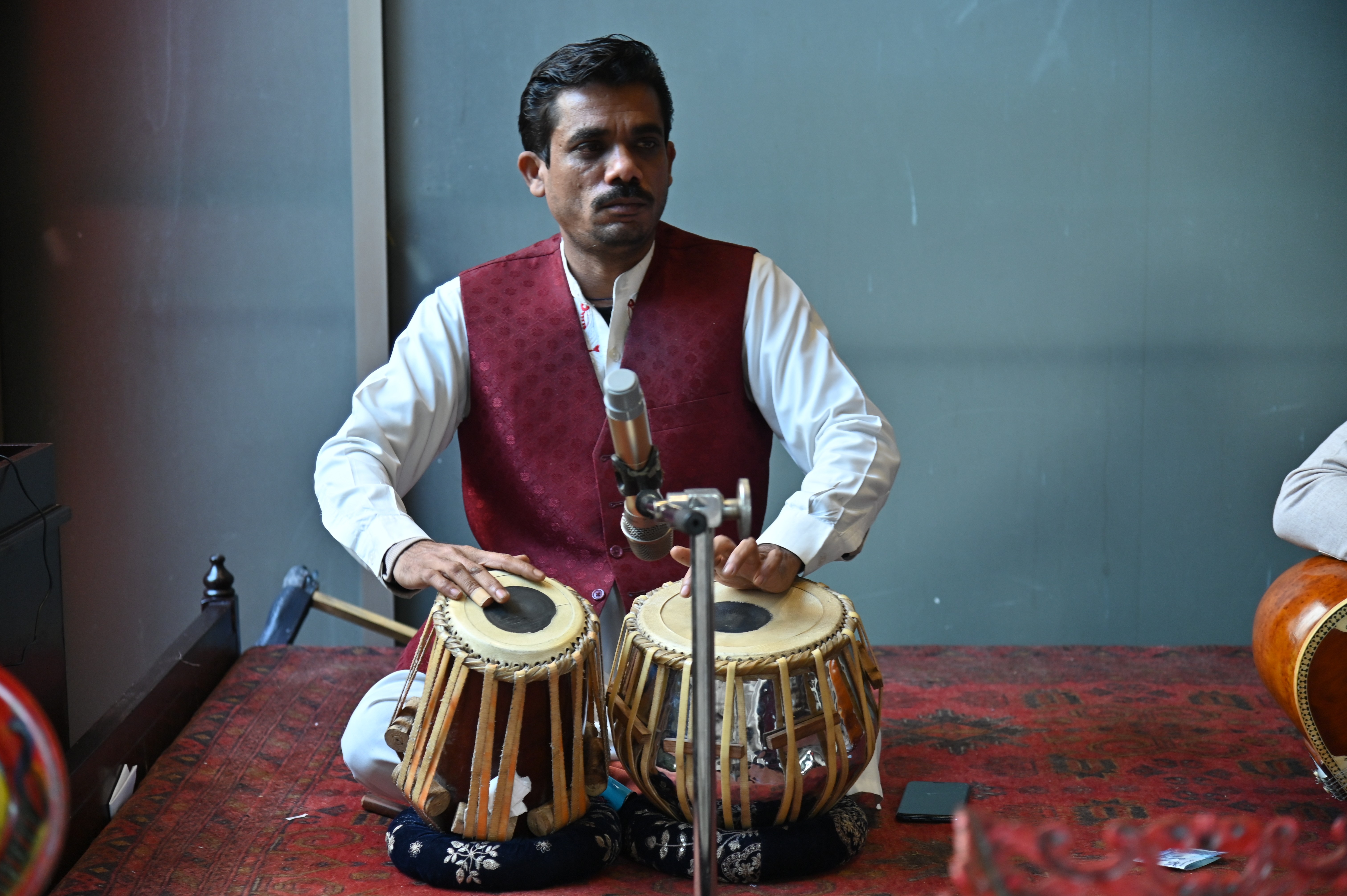 A musician playing Tabla:  a pair of hand drums common in the subcontinent culture