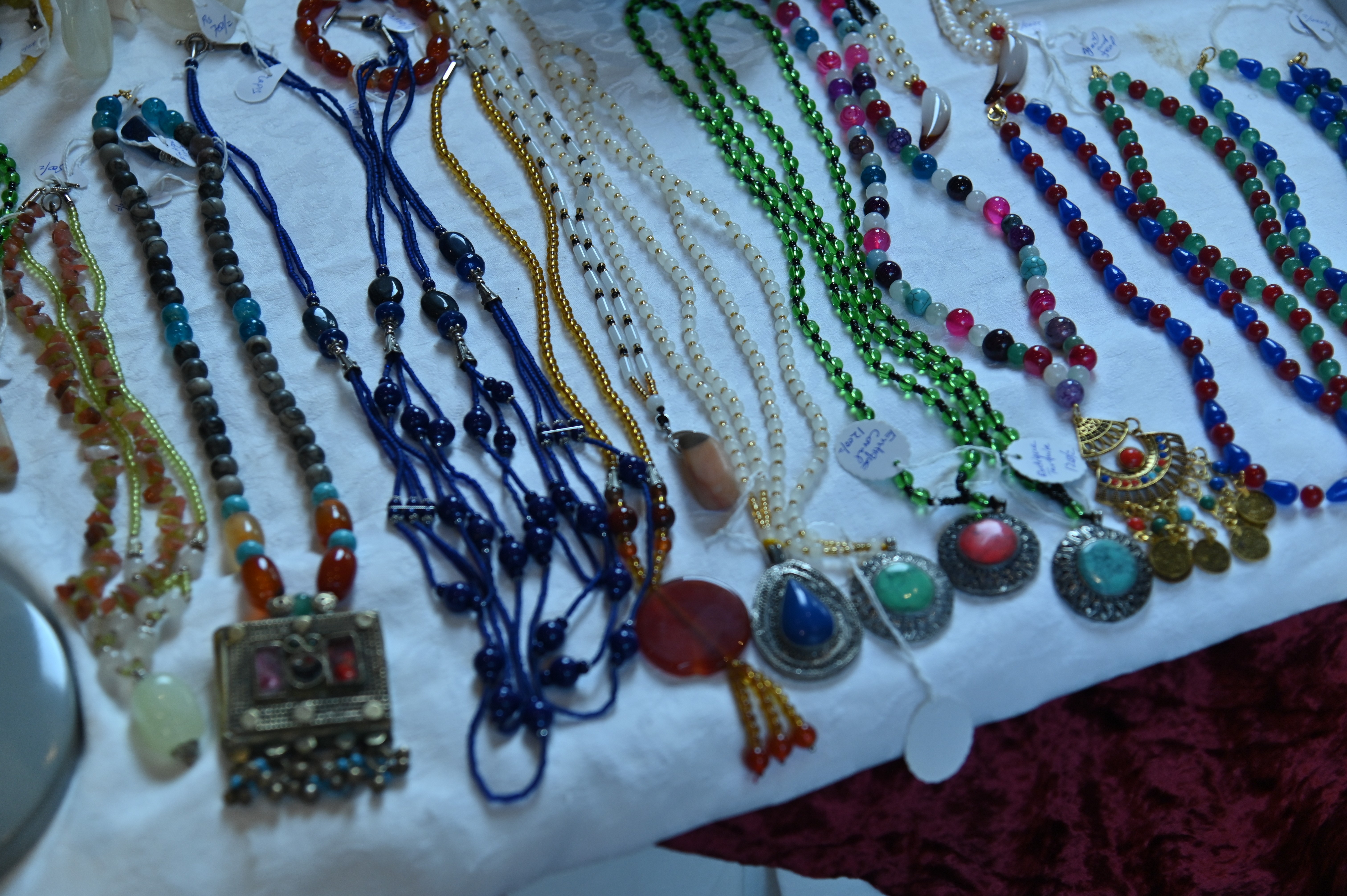 A stall of elegant vintage jewelry adorned with pearls and stones.
