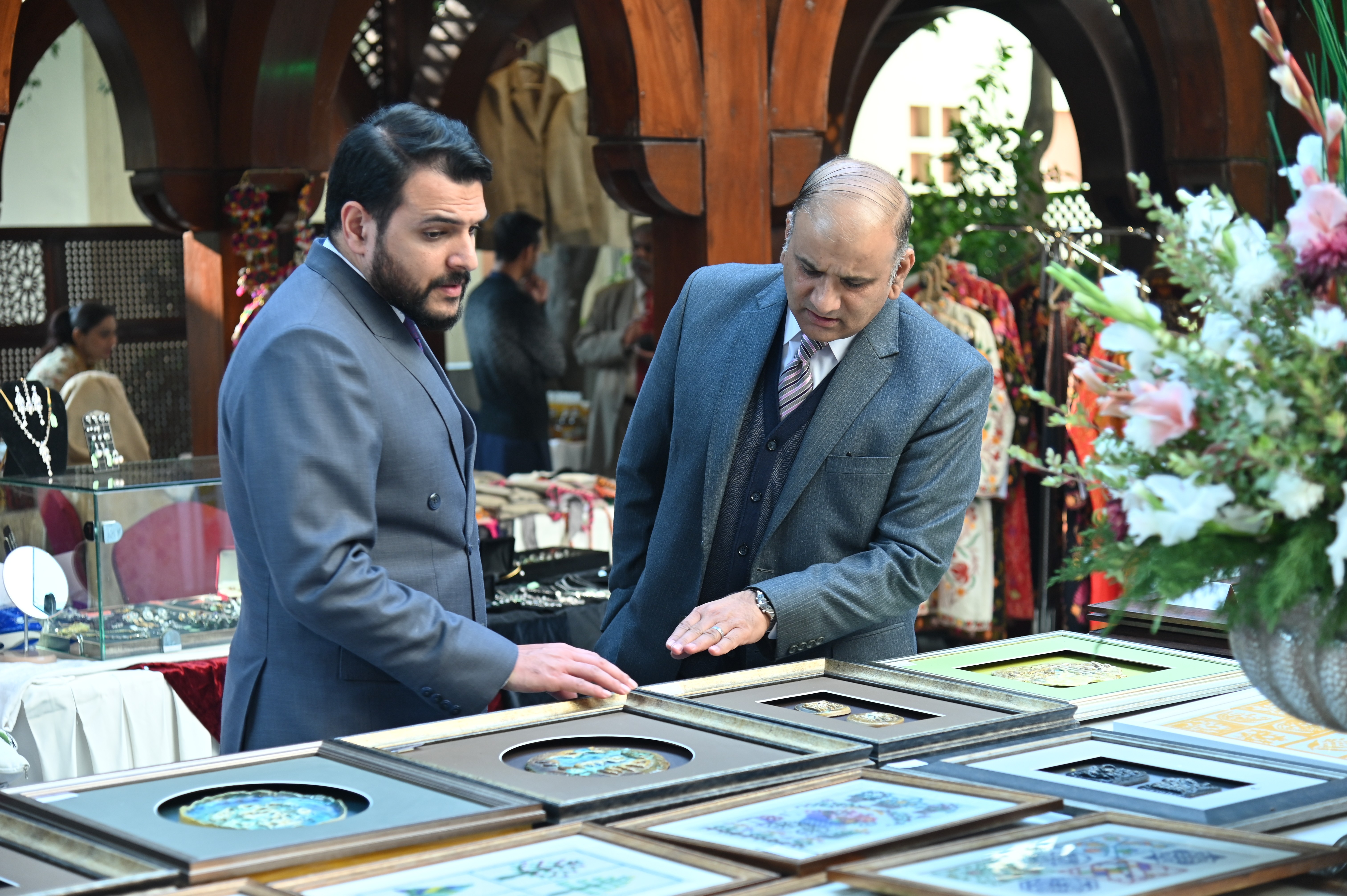 Visitors at the stall of colorful painting frames