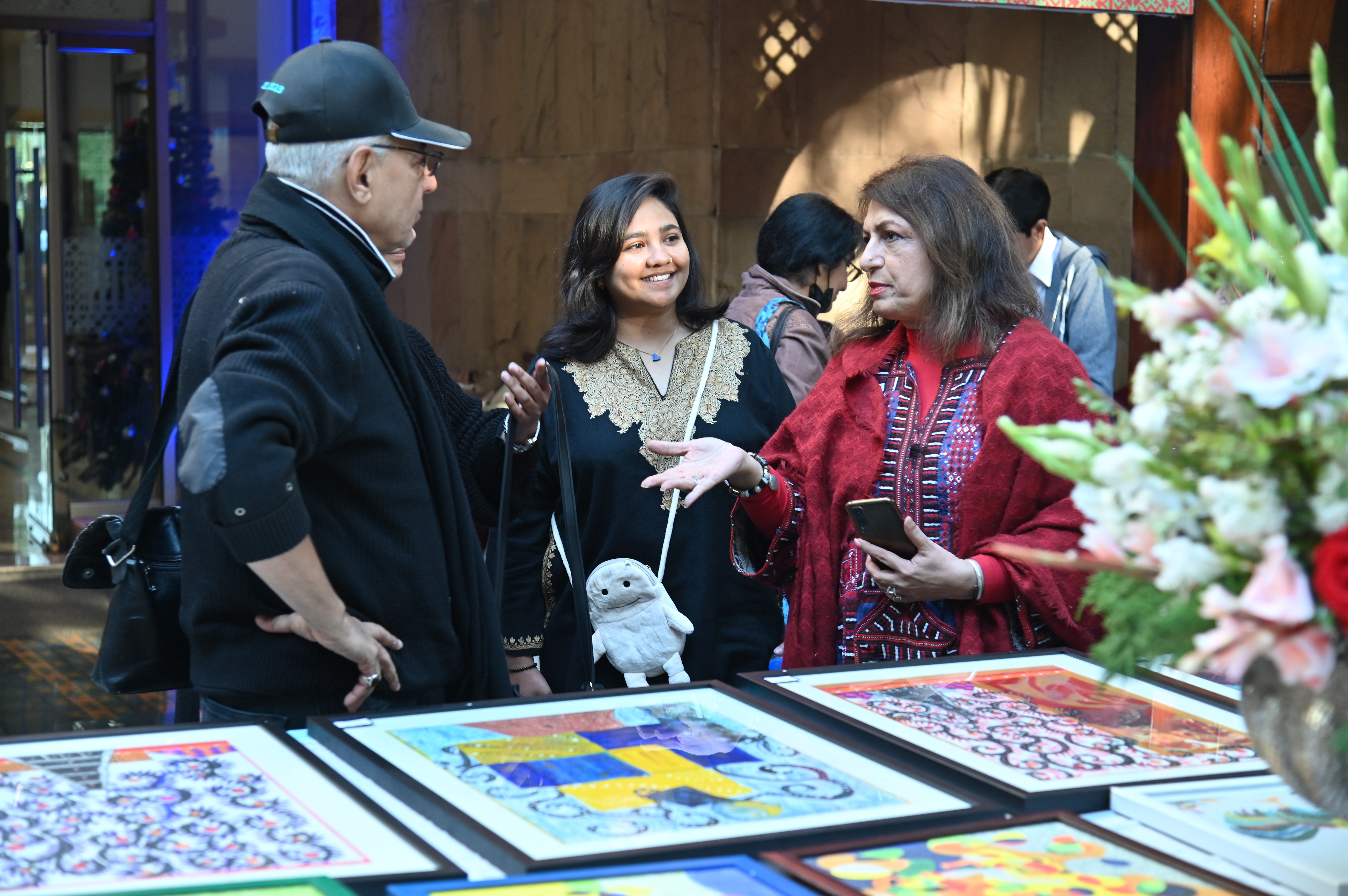 Visitors at the stall of colorful painting frames