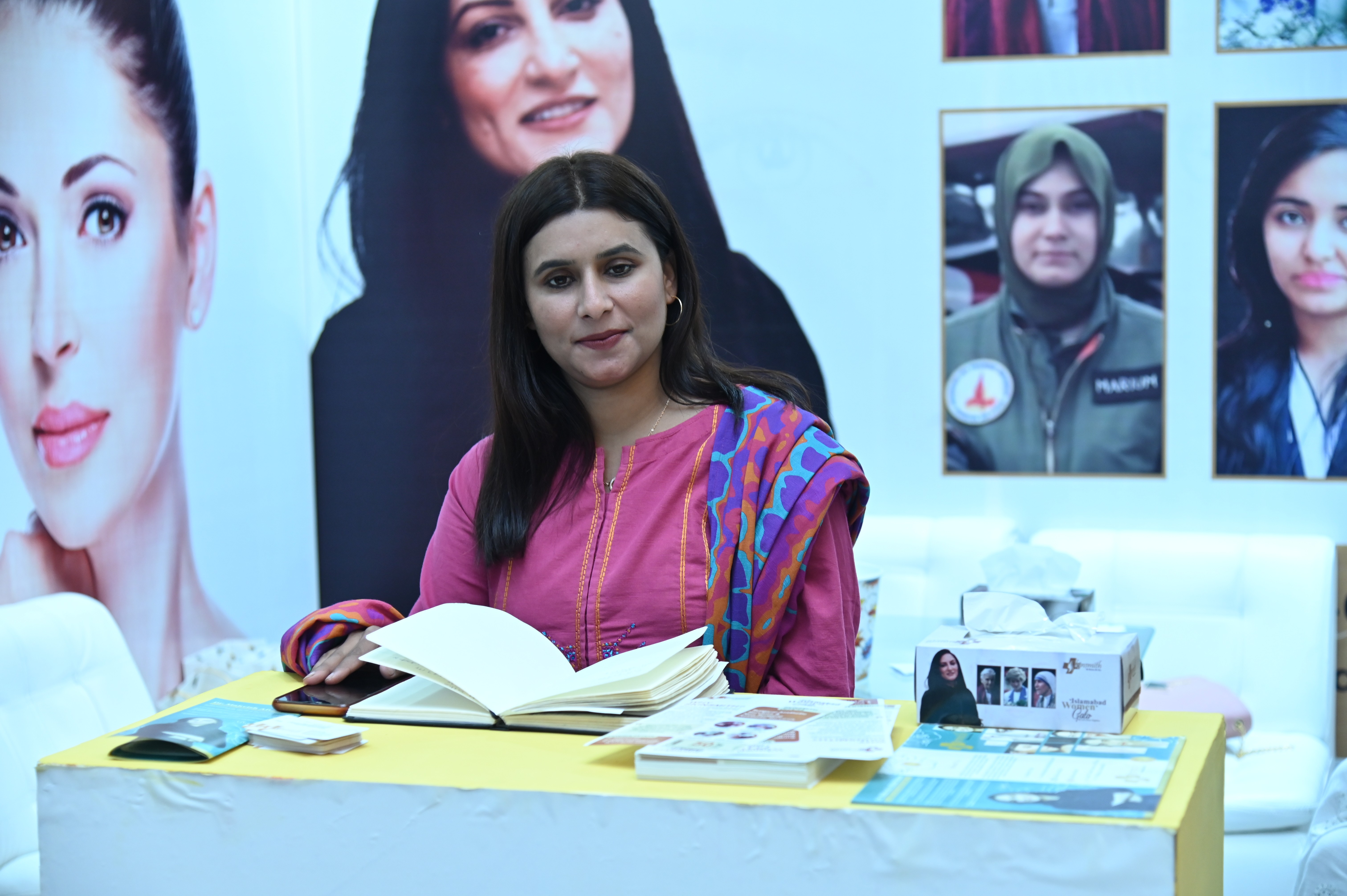 The portrait of a woman reading book at Islamabad Women Gala 2023