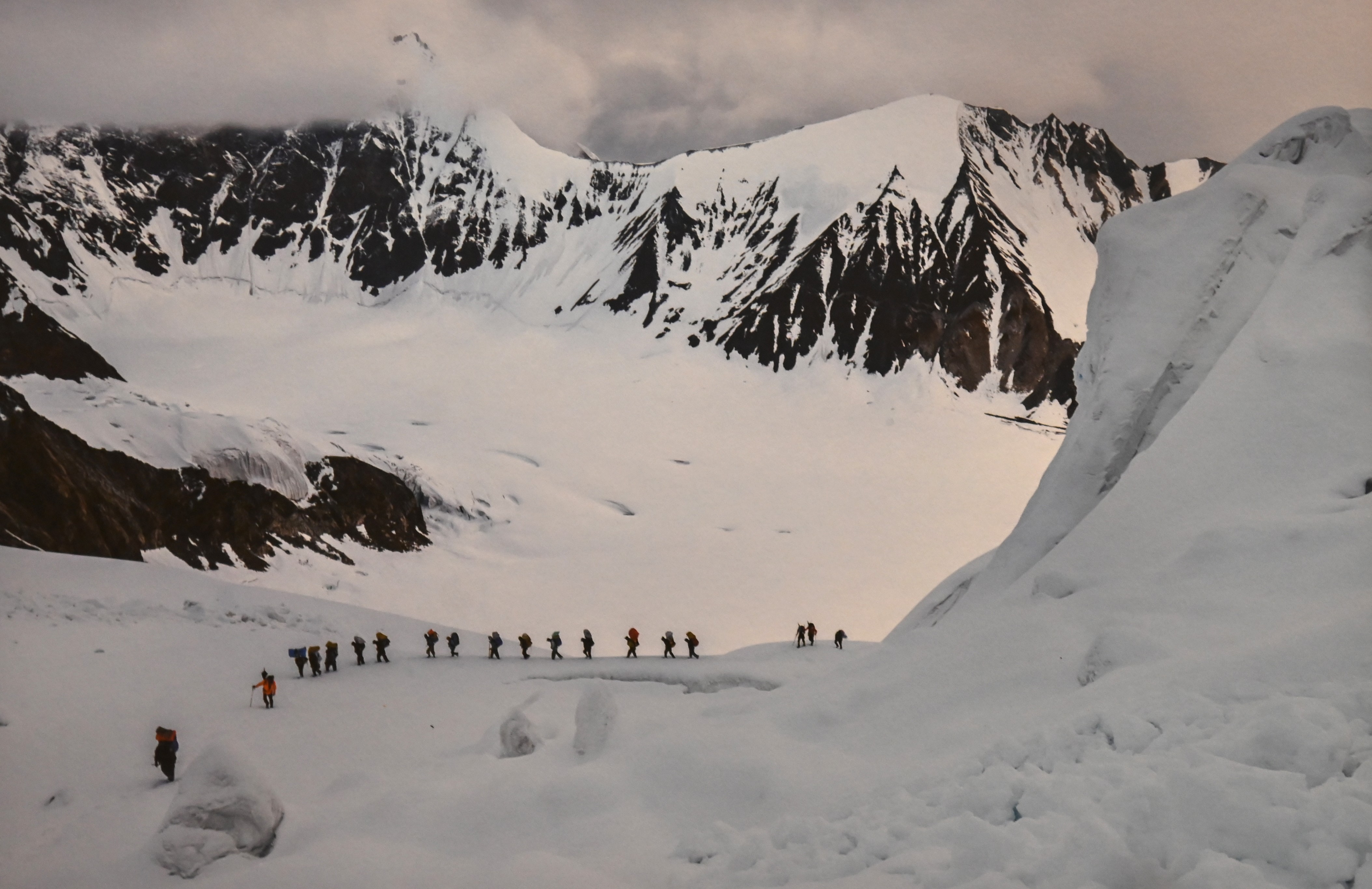 The climbers passing by the snow covered mountain