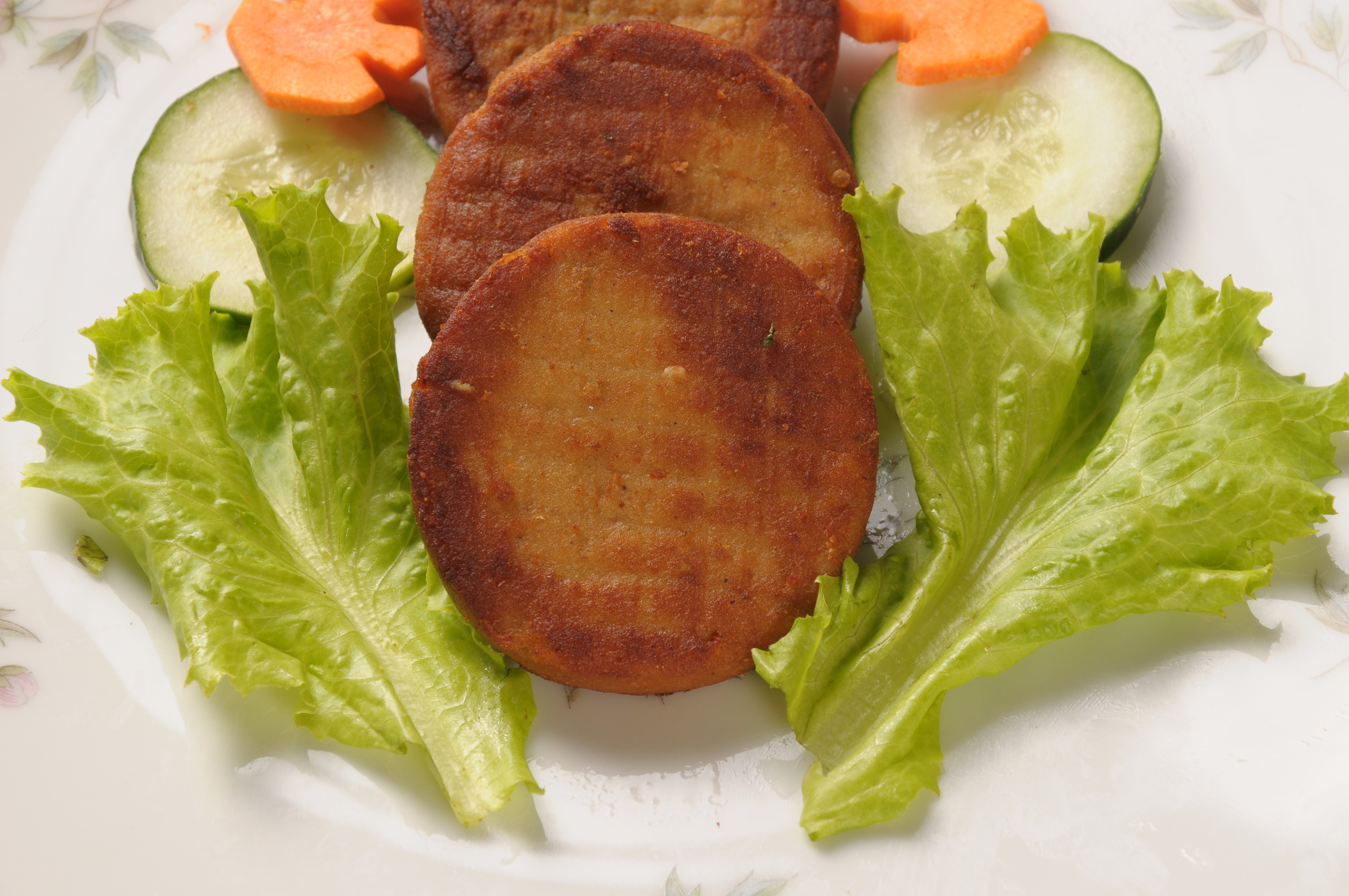 Crispy fried shami kabab (A round patty of minced lamb and lentils cooked in a tandoor; often served with a small salad with a yoghurt and mint dressing)