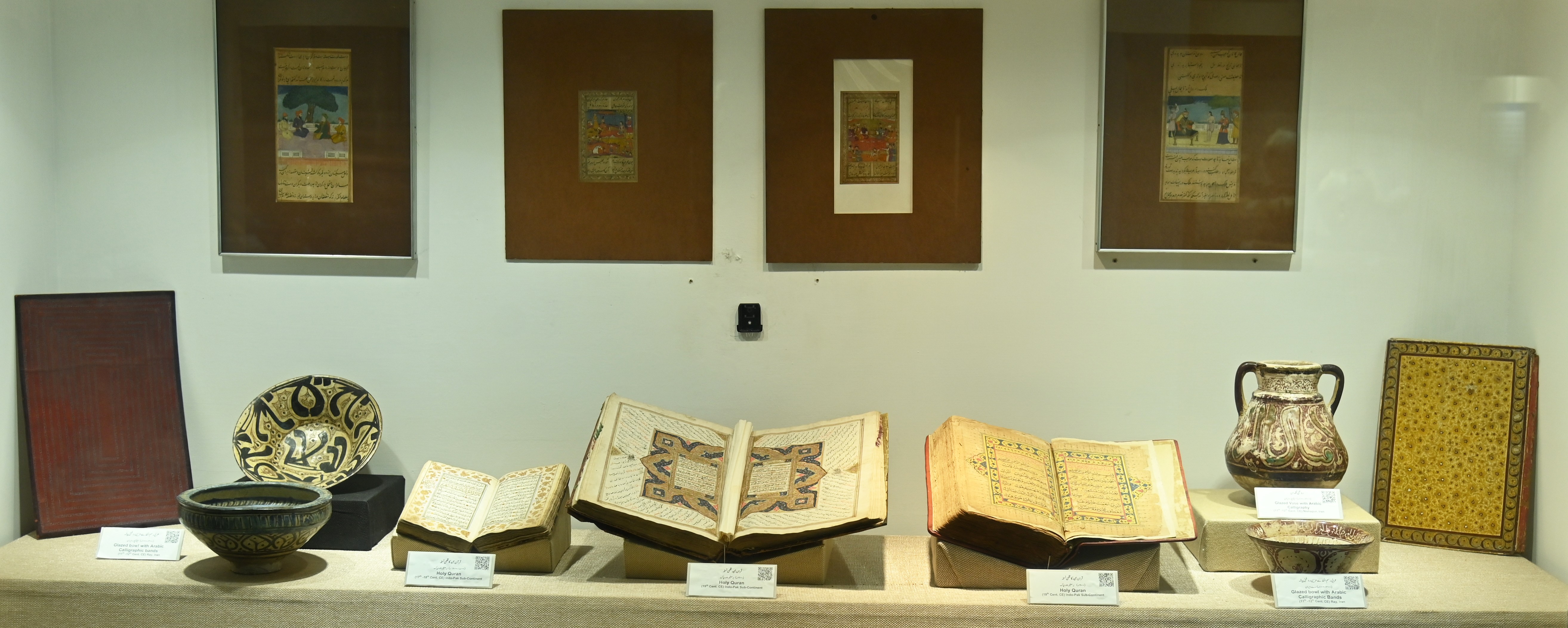 The collection of Rare Quran Manuscripts and Glazed Bowls with Arabic Calligraphic Bands
