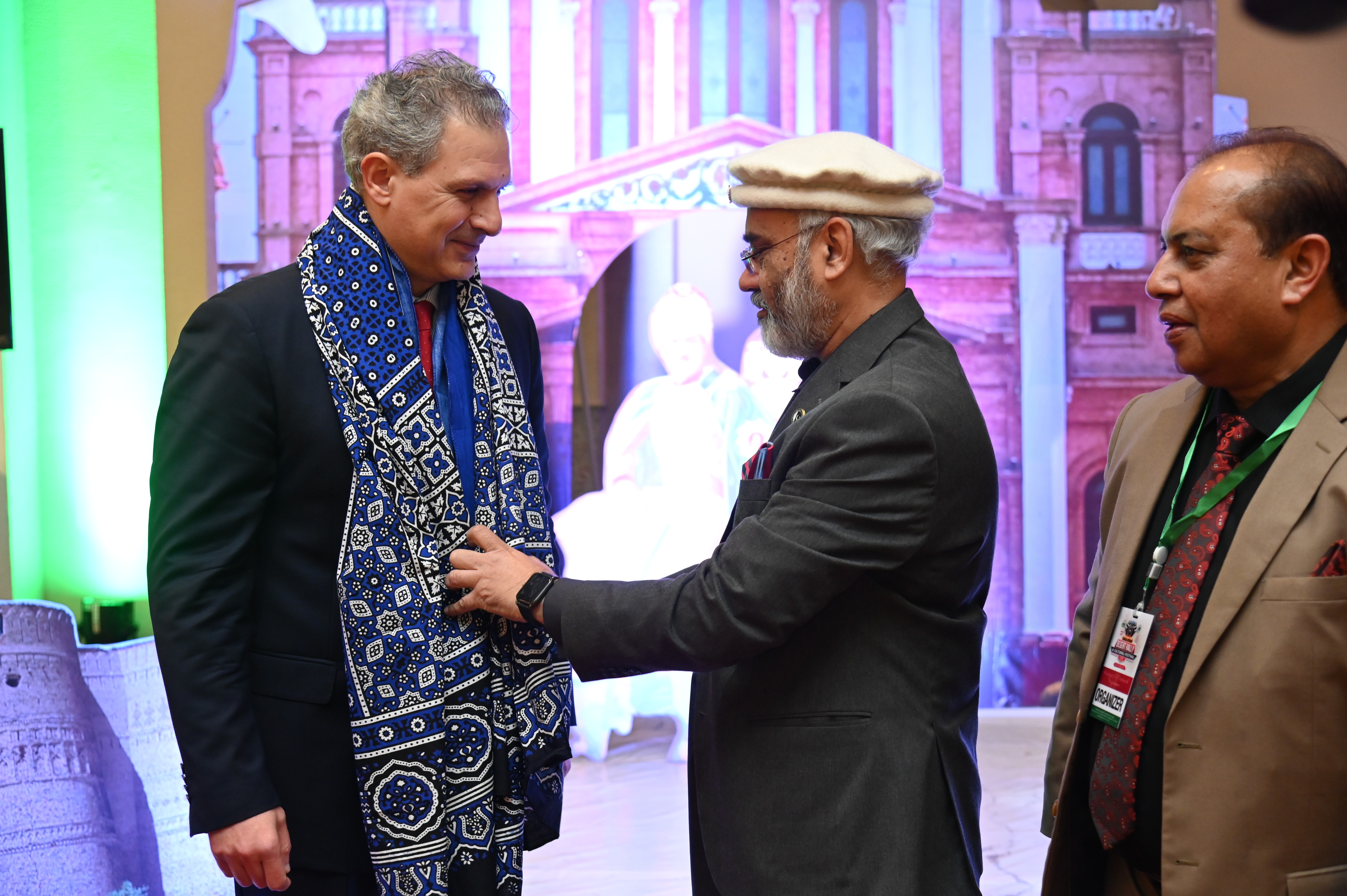 Aftab Ur Rehman giving an Ajrak to the chief guest as a good will gesture