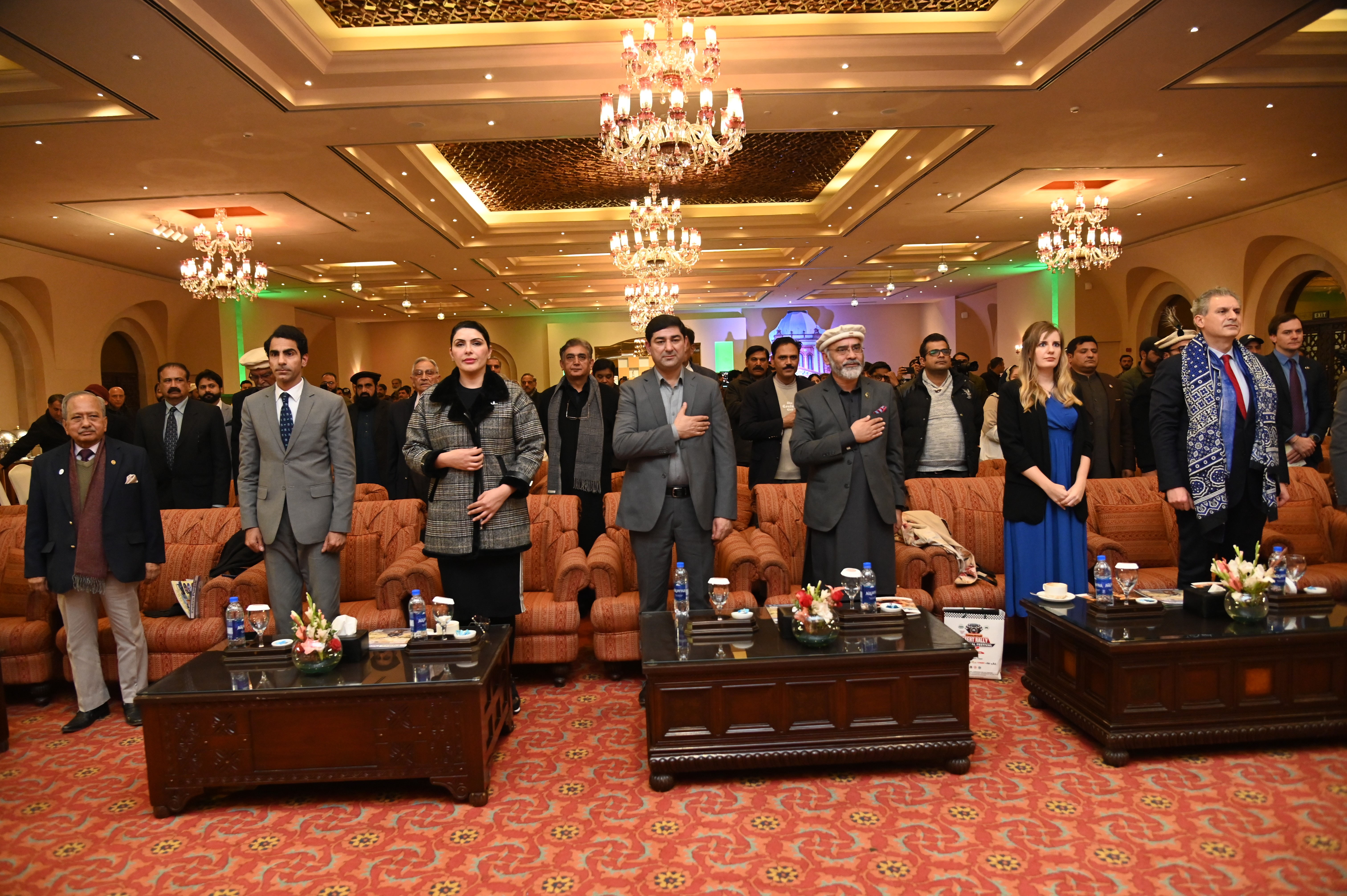 The participants standing in honor of The National Anthem of Pakistan