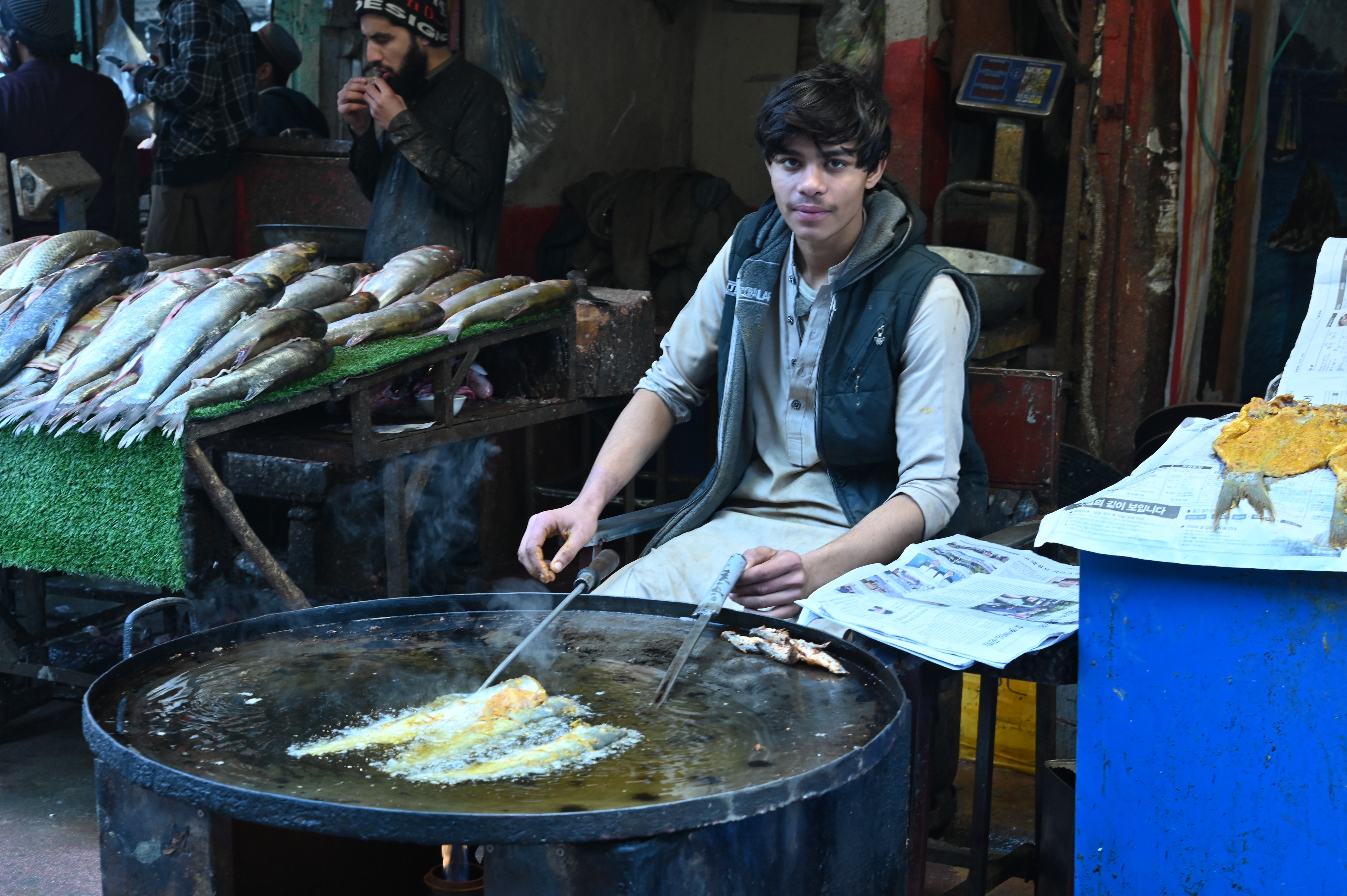 A boy selling fried fish