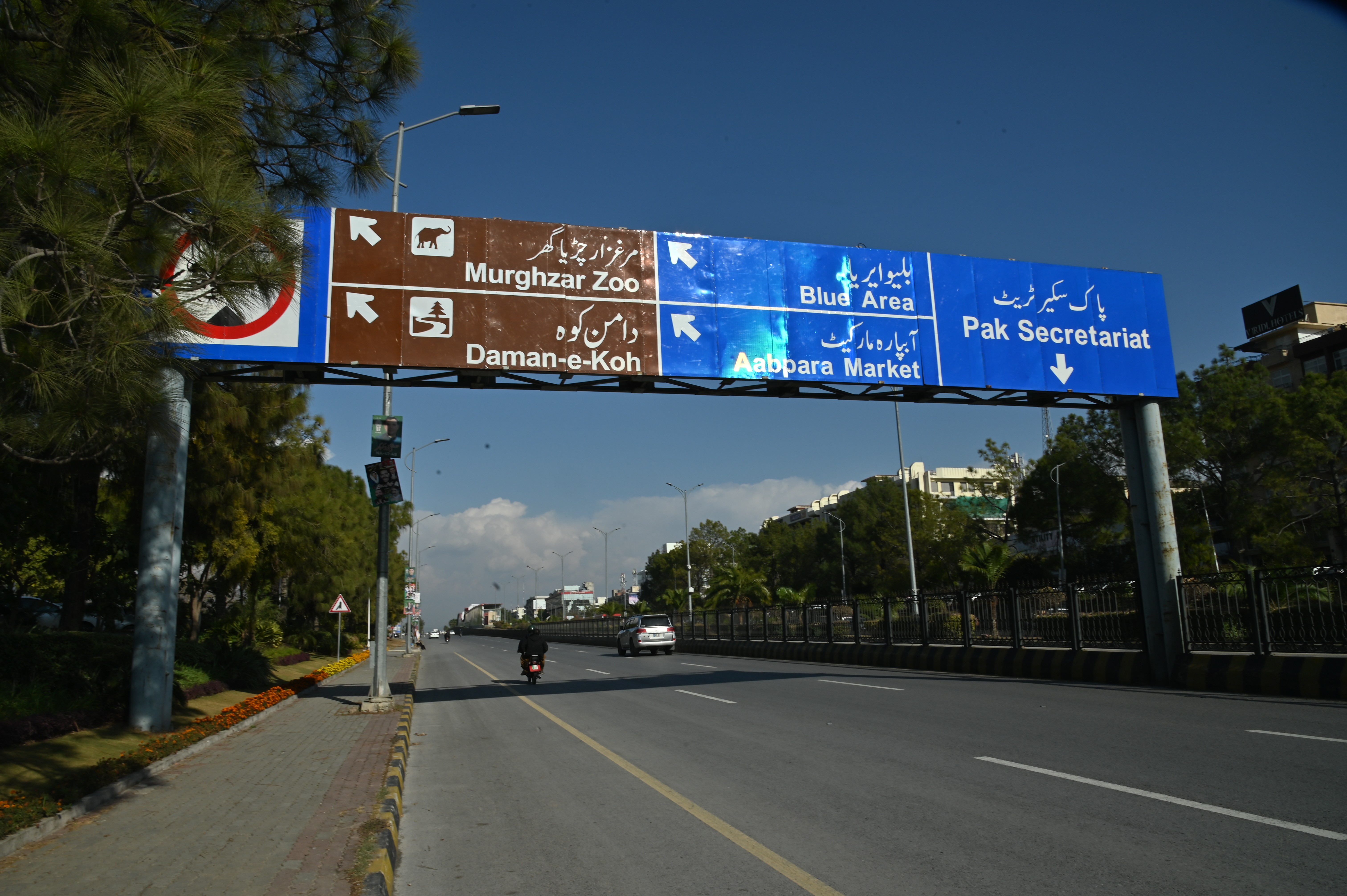 A board displaying directions of various locations in Islamabad