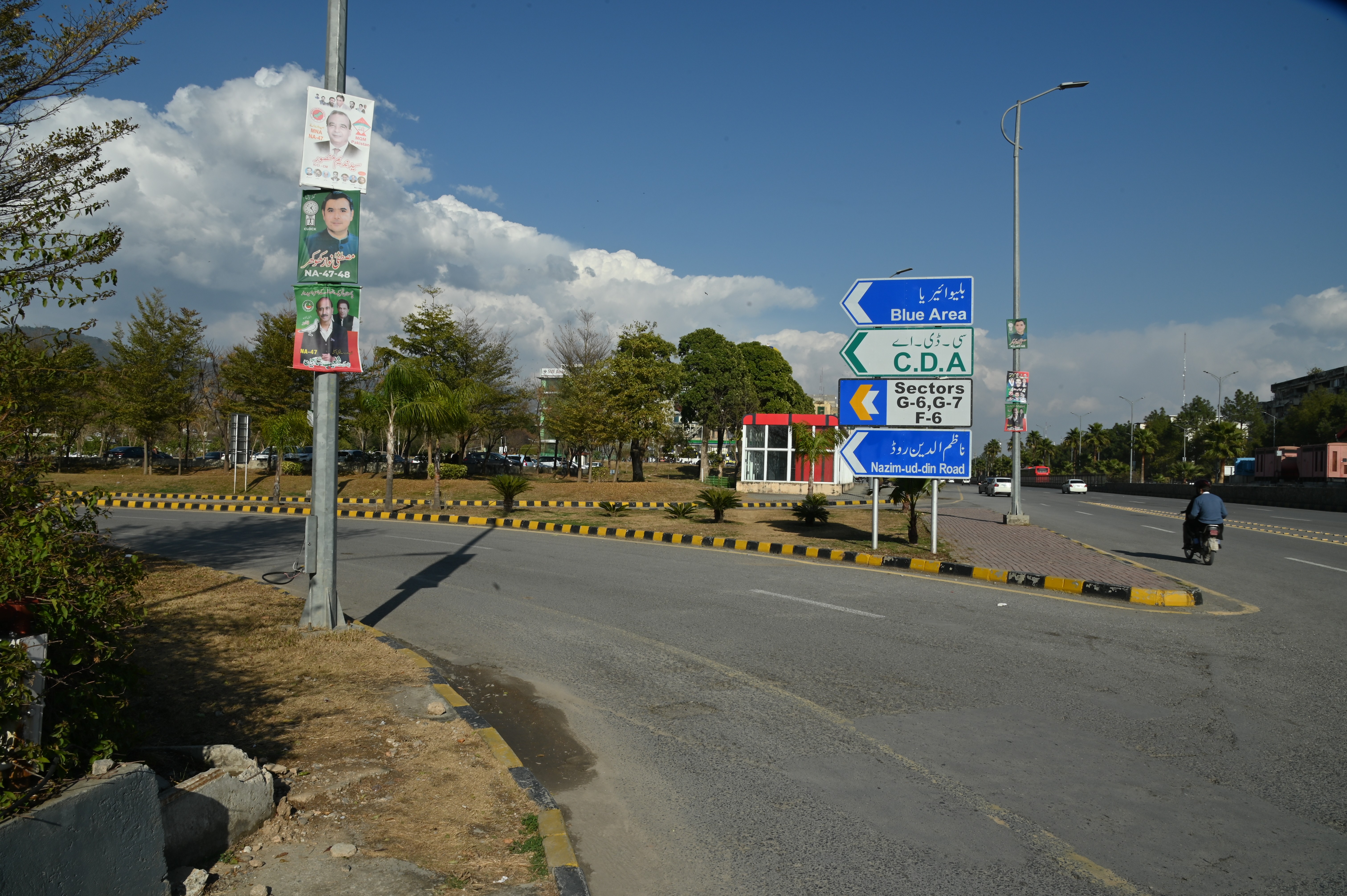 A board displaying directions of various locations in Islamabad