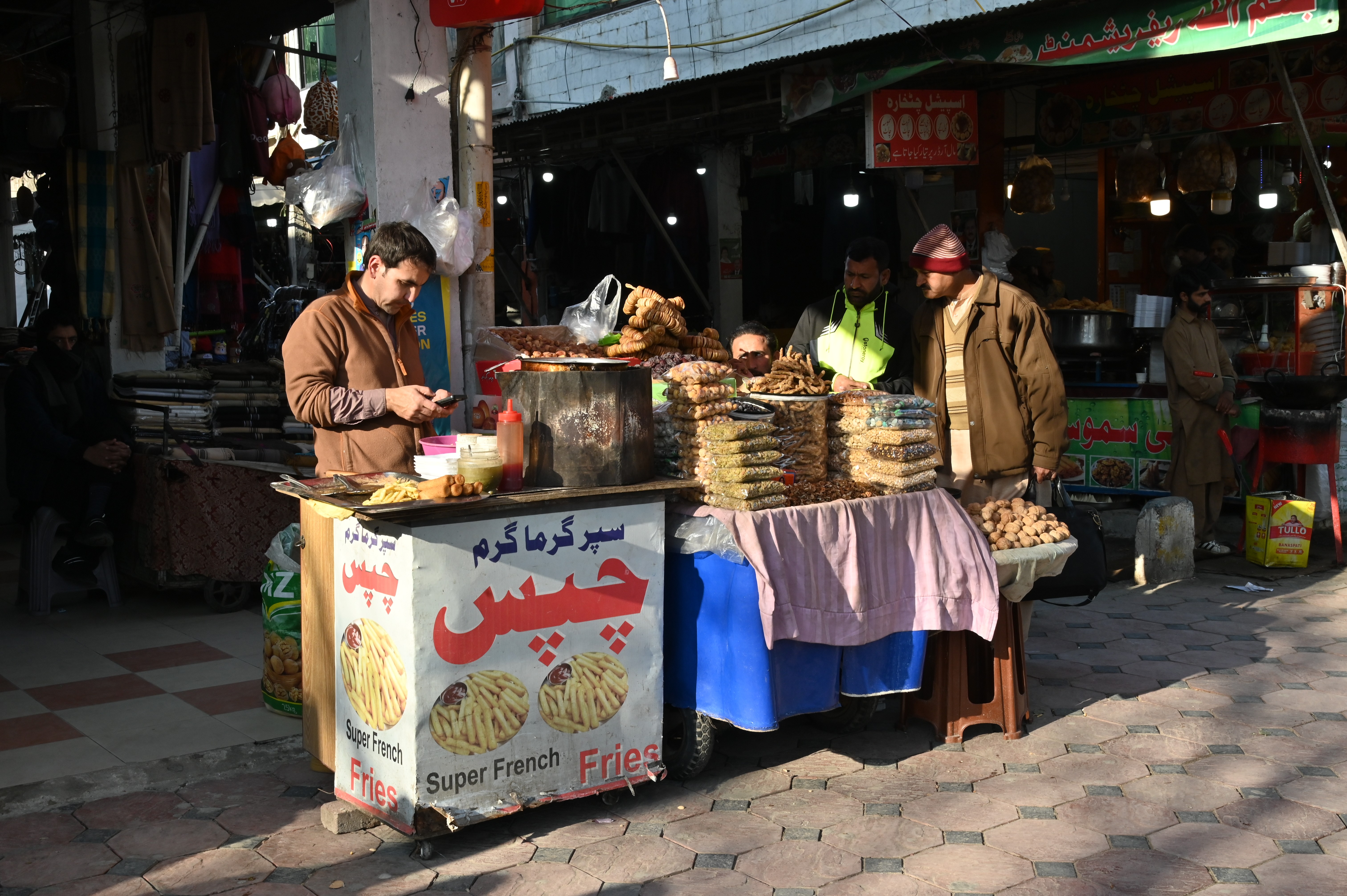 A man selling french fries at his stall