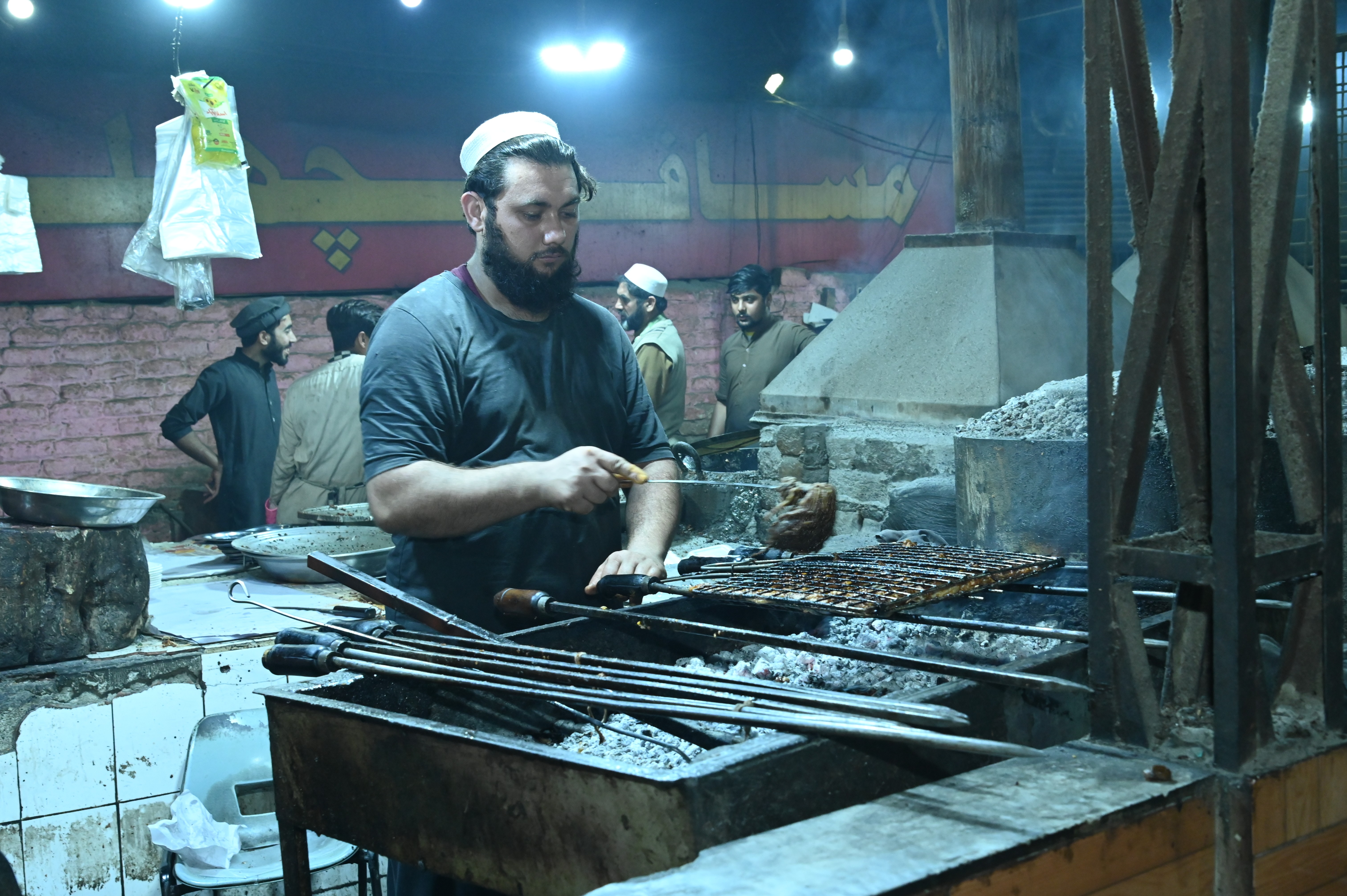 A man making BBQ grilled fish