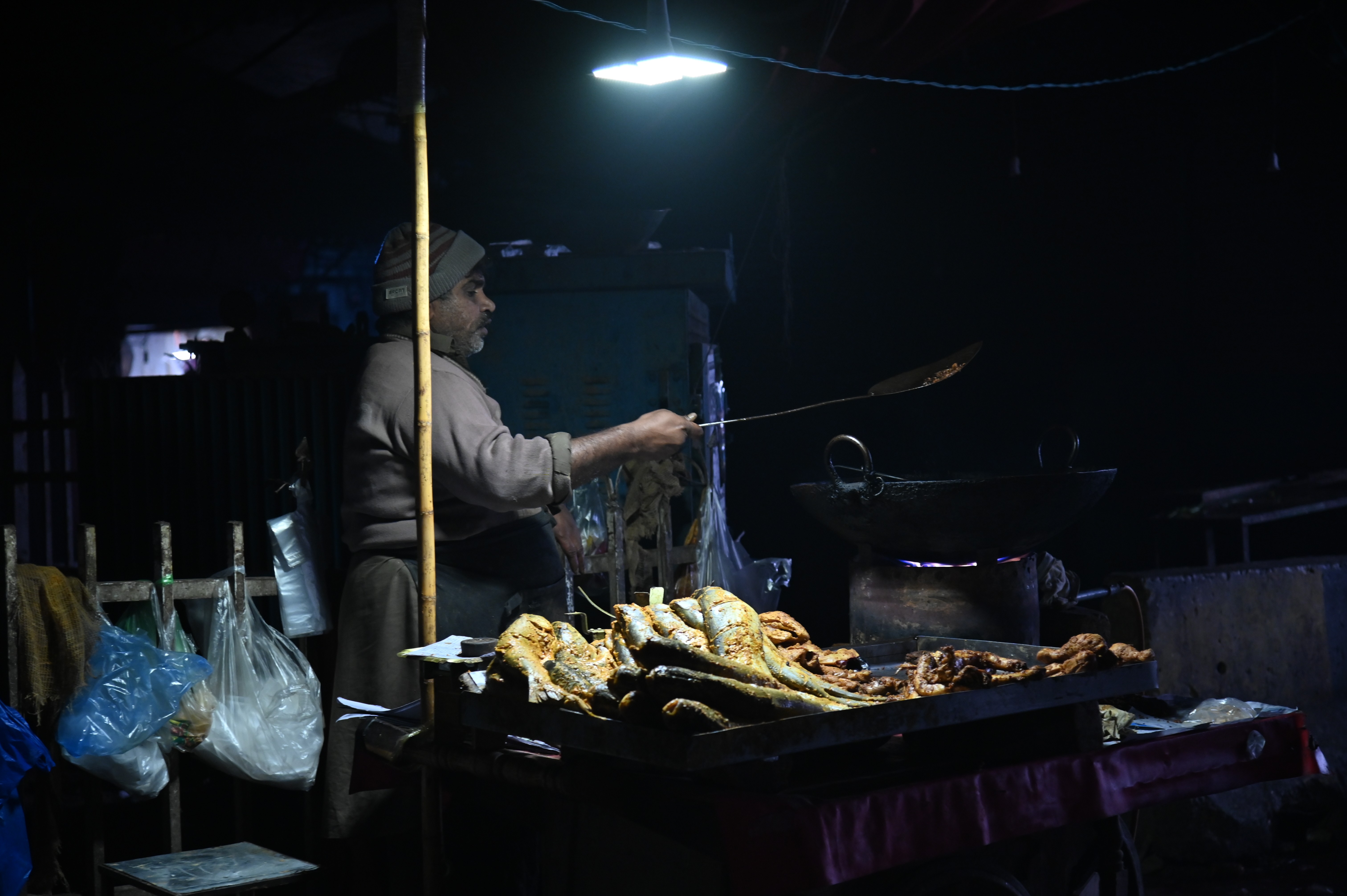 A man busy in frying the fish