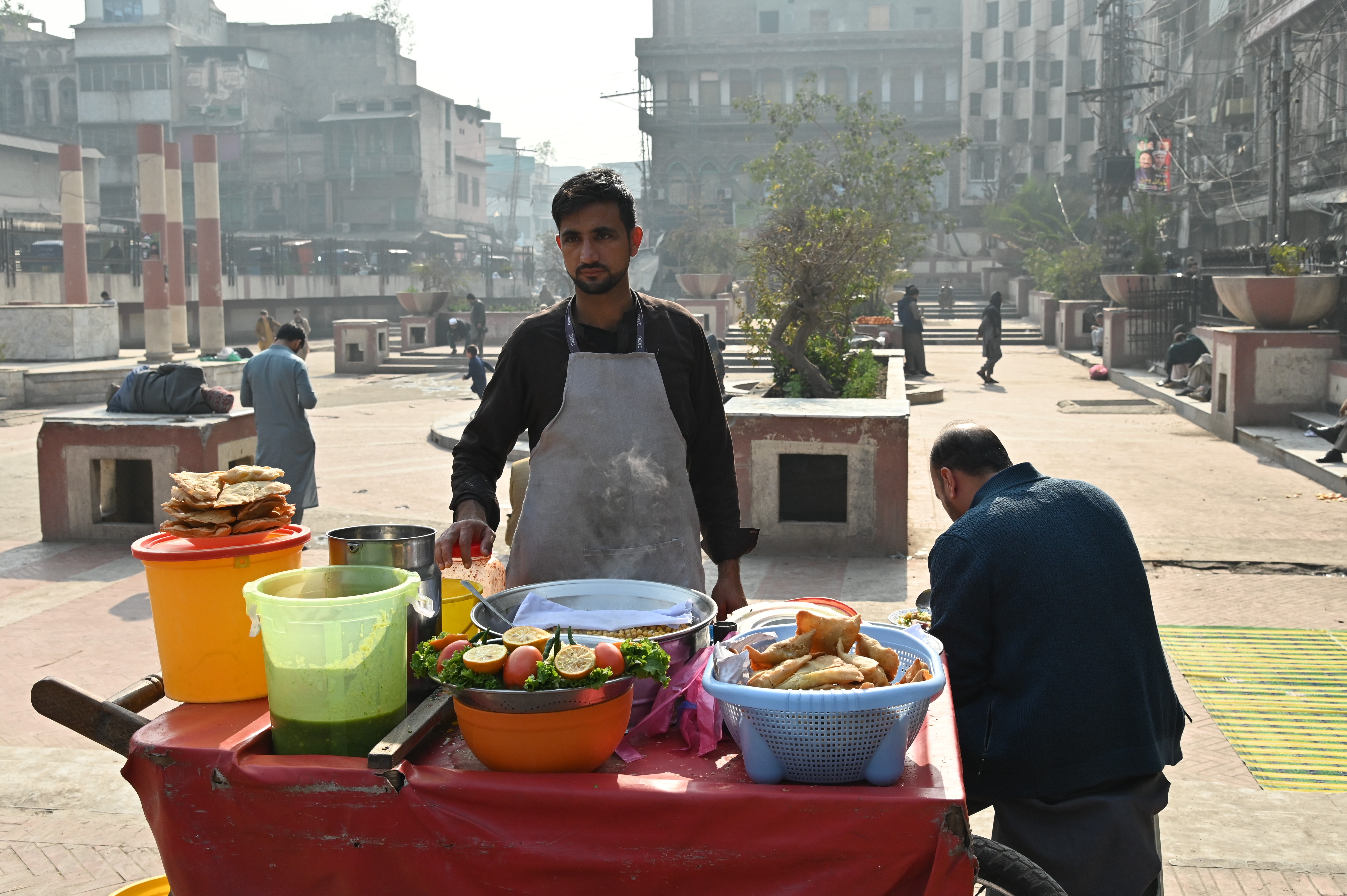 A man selling Samosa Chaat