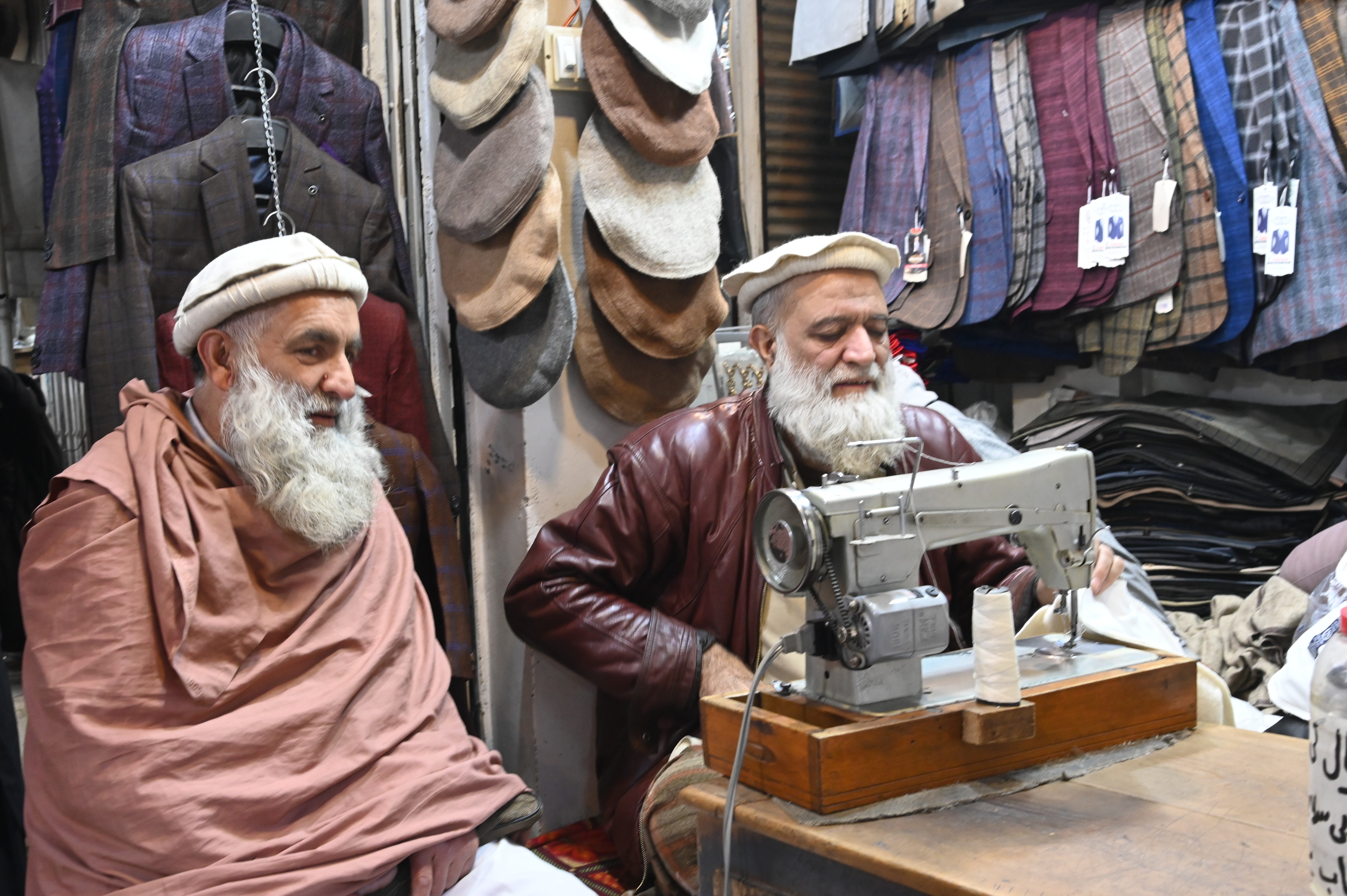 A tailor busy in stitching the warm clothes