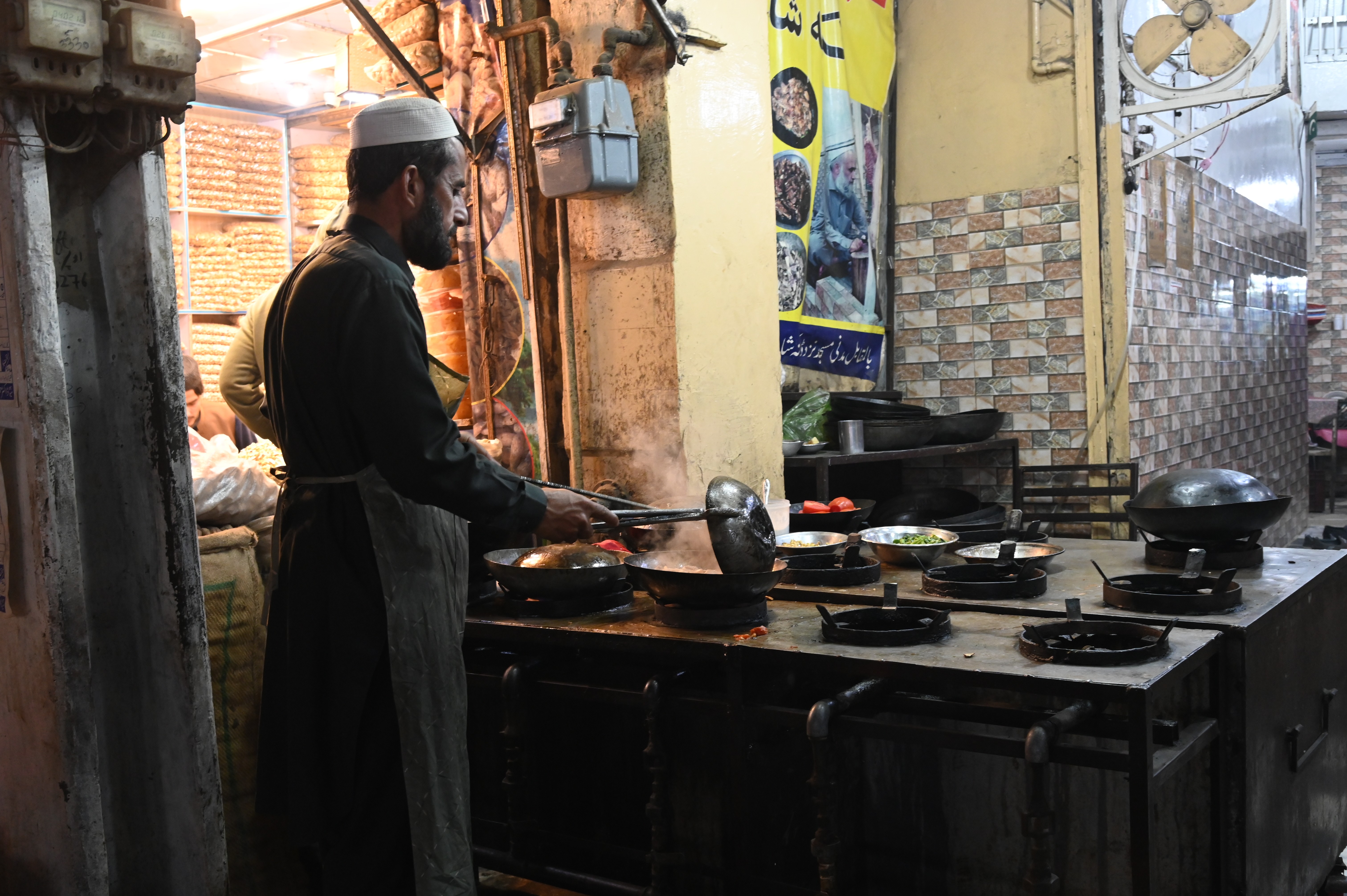 A man busy in making chicken karahi