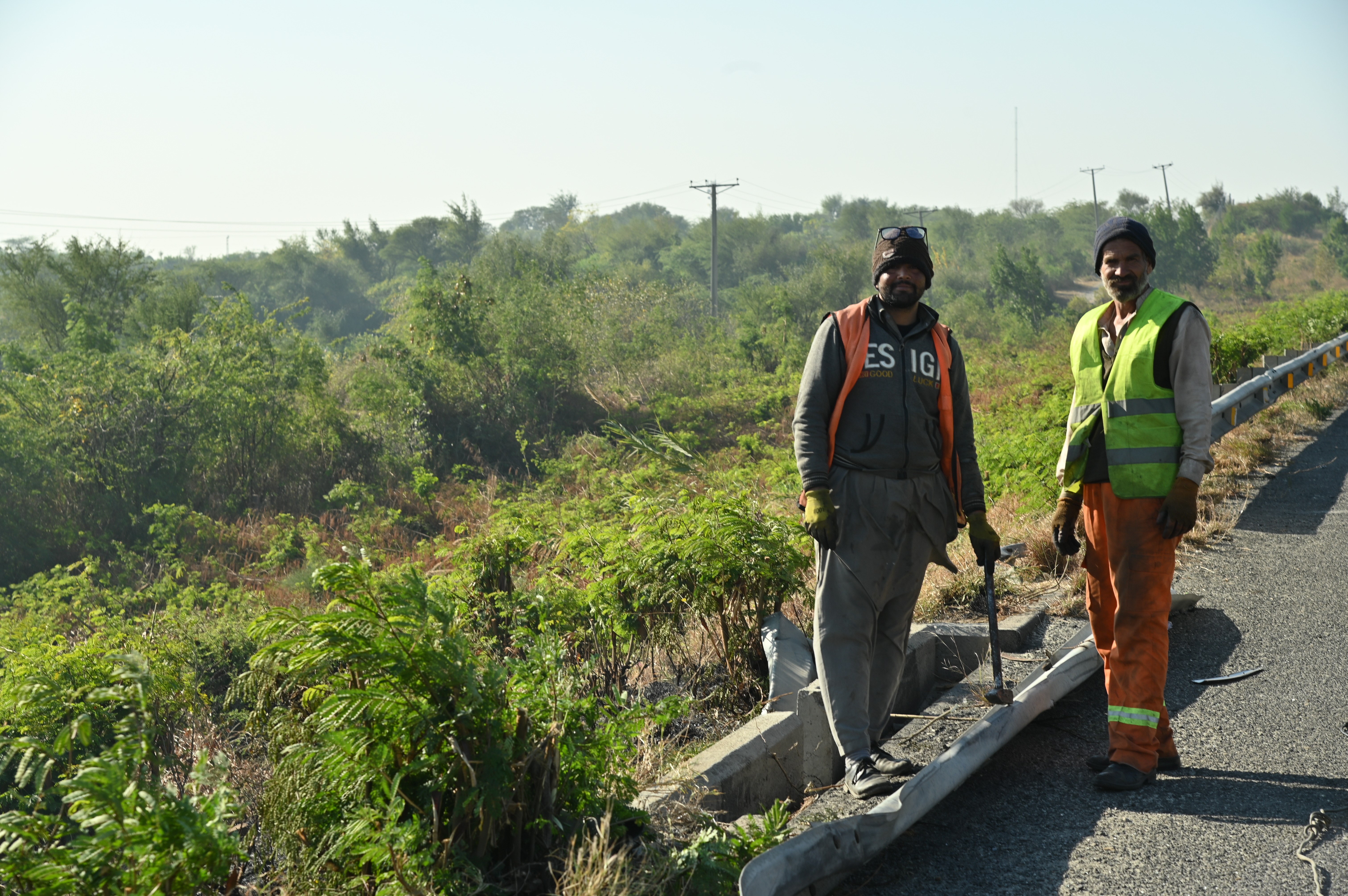 Men busy in fencing the roads