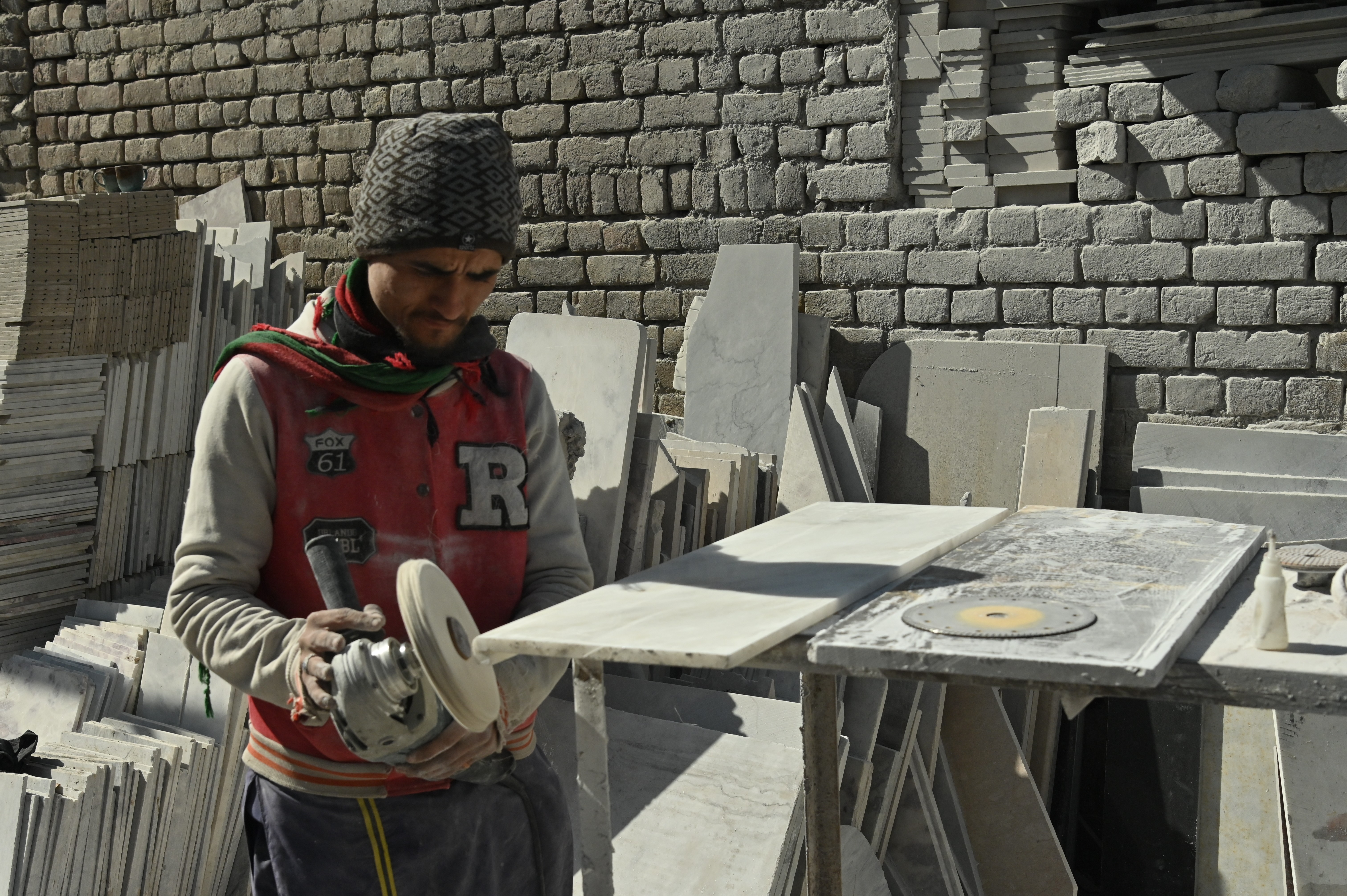 A man busy in refining marble slabs