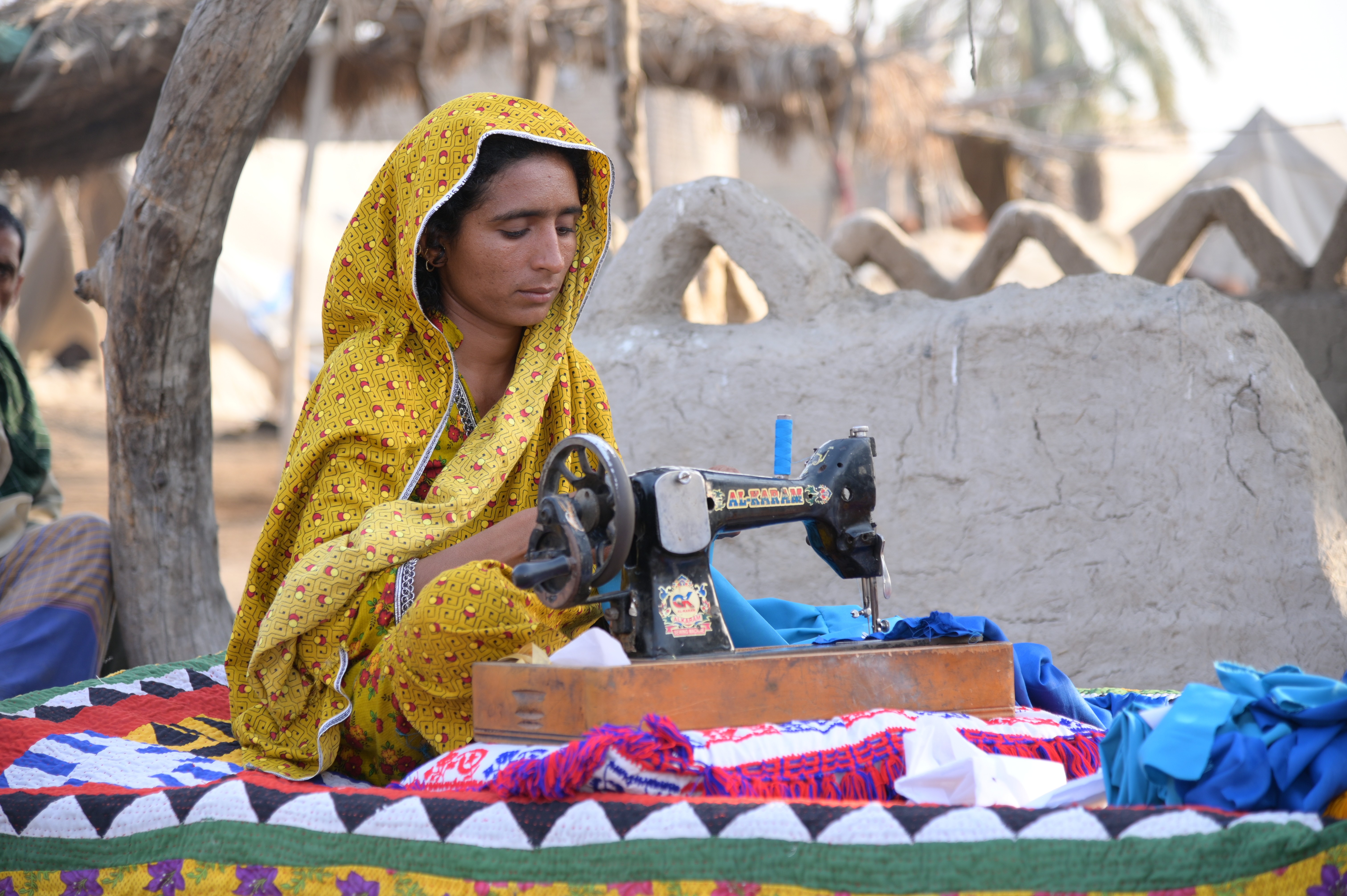 A woman busy in sewing dress