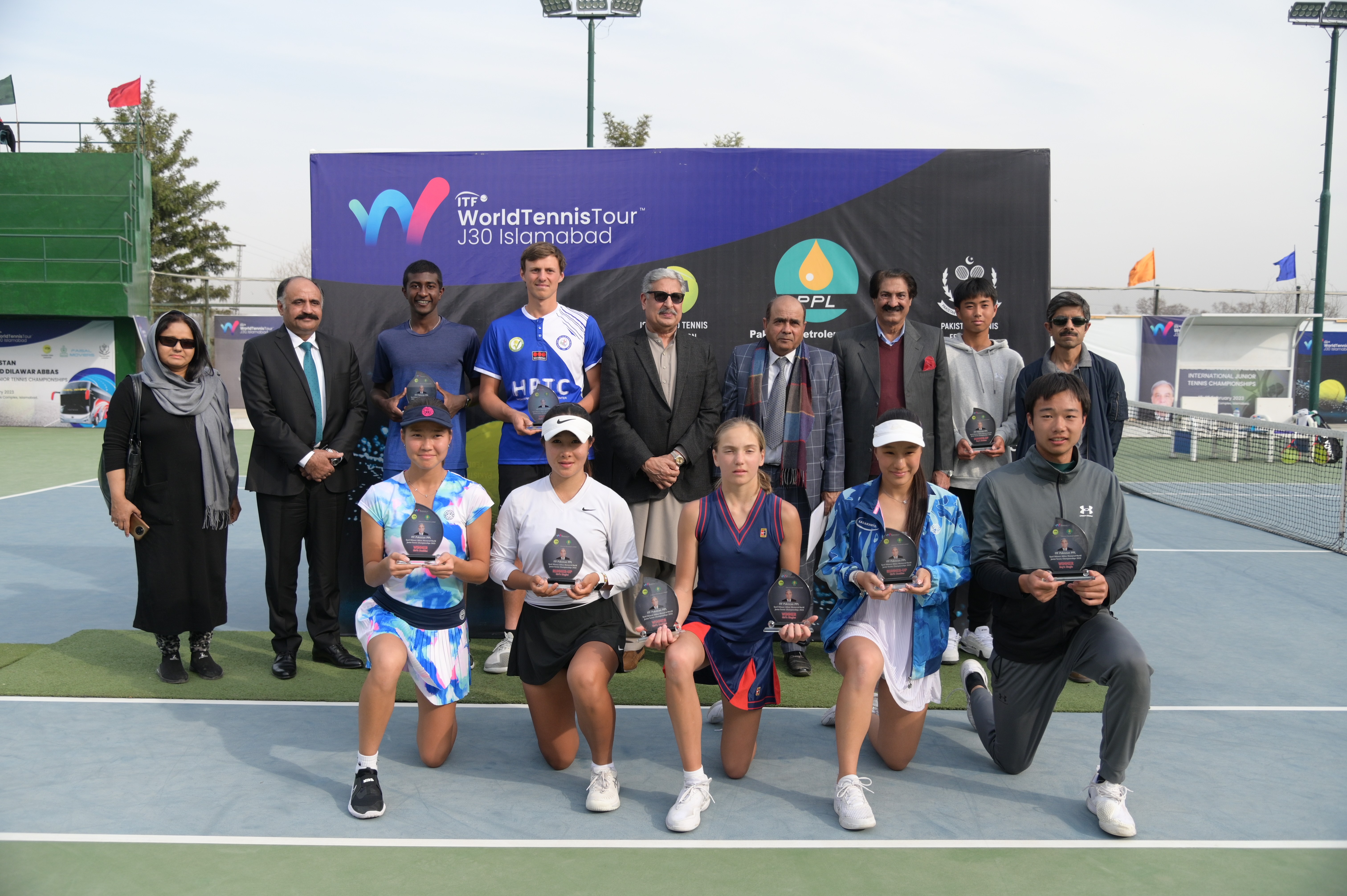 A group photo of winning tennis players