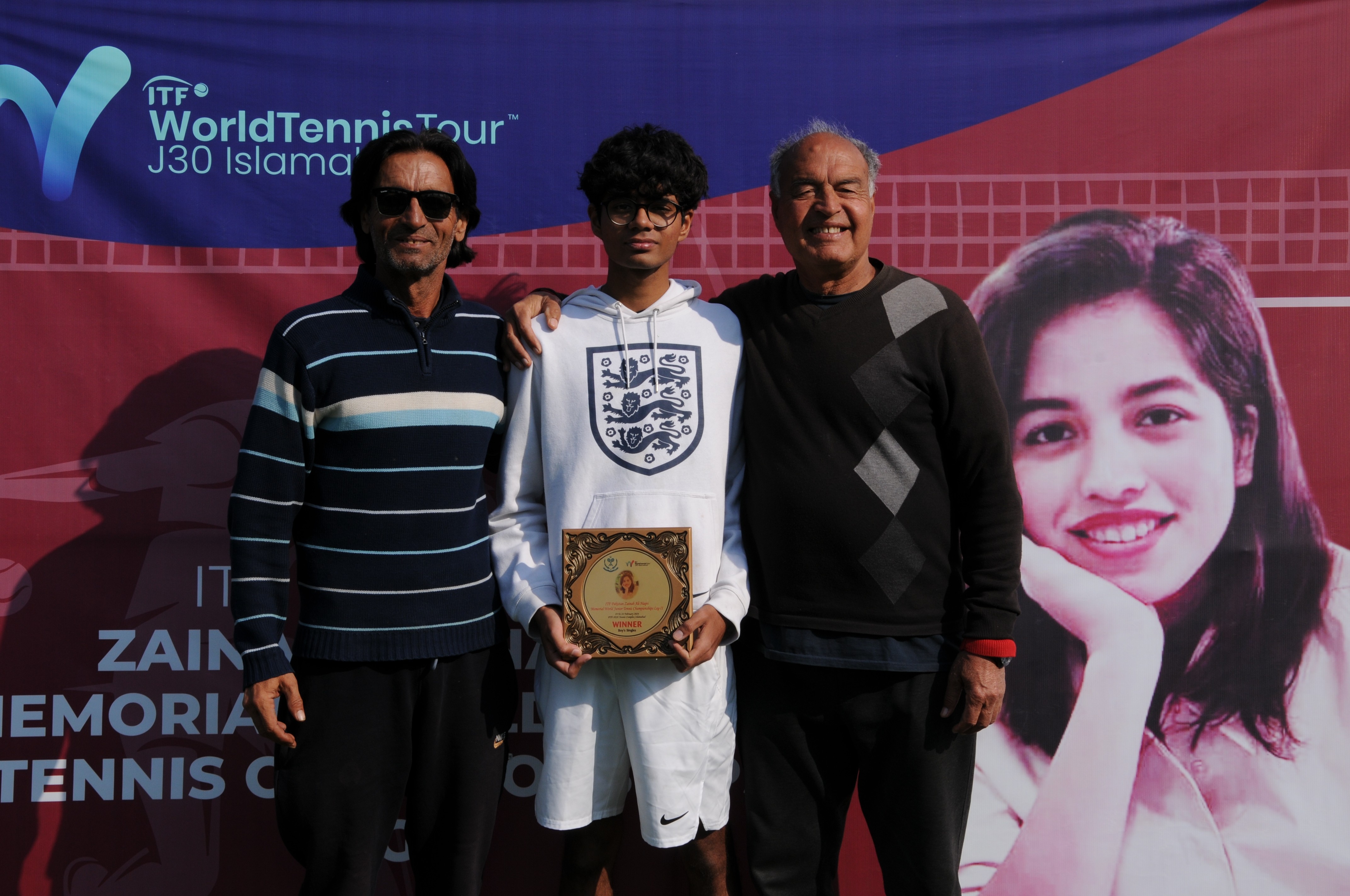 A group photo of tennis player with coaches after winning