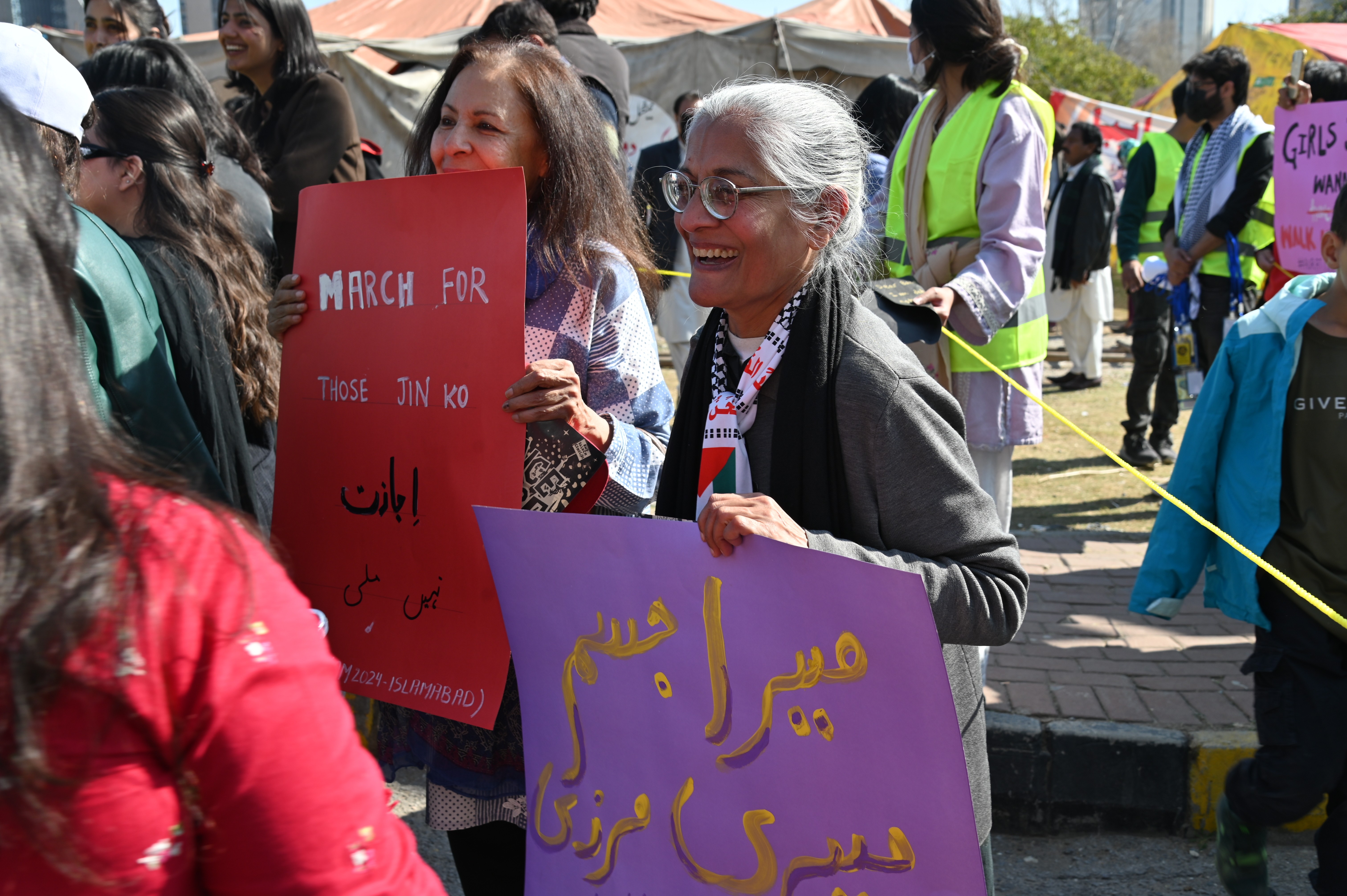 Women holding different banners at Aurat March 2024