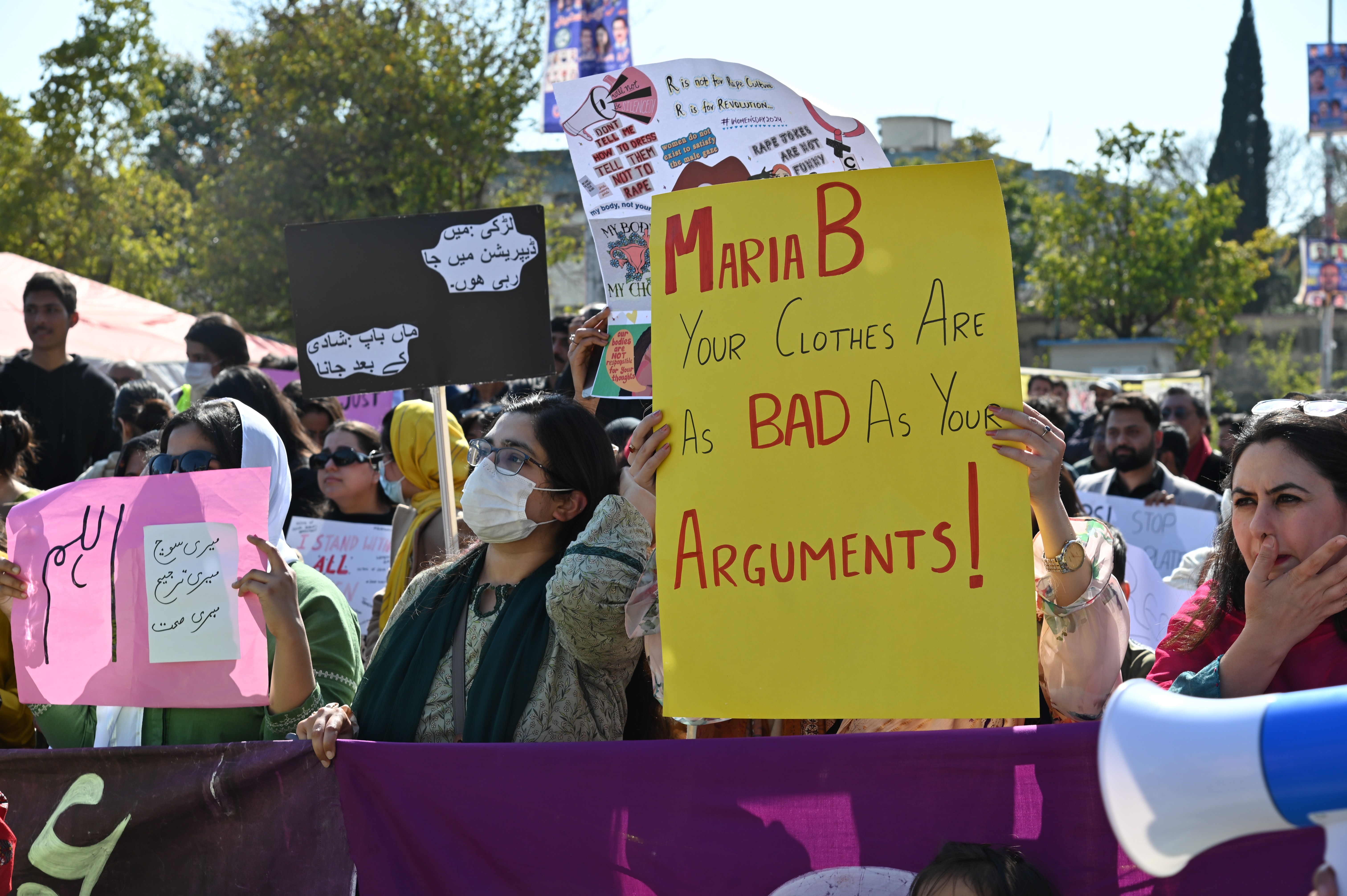 Women holding different banners at Aurat March 2024