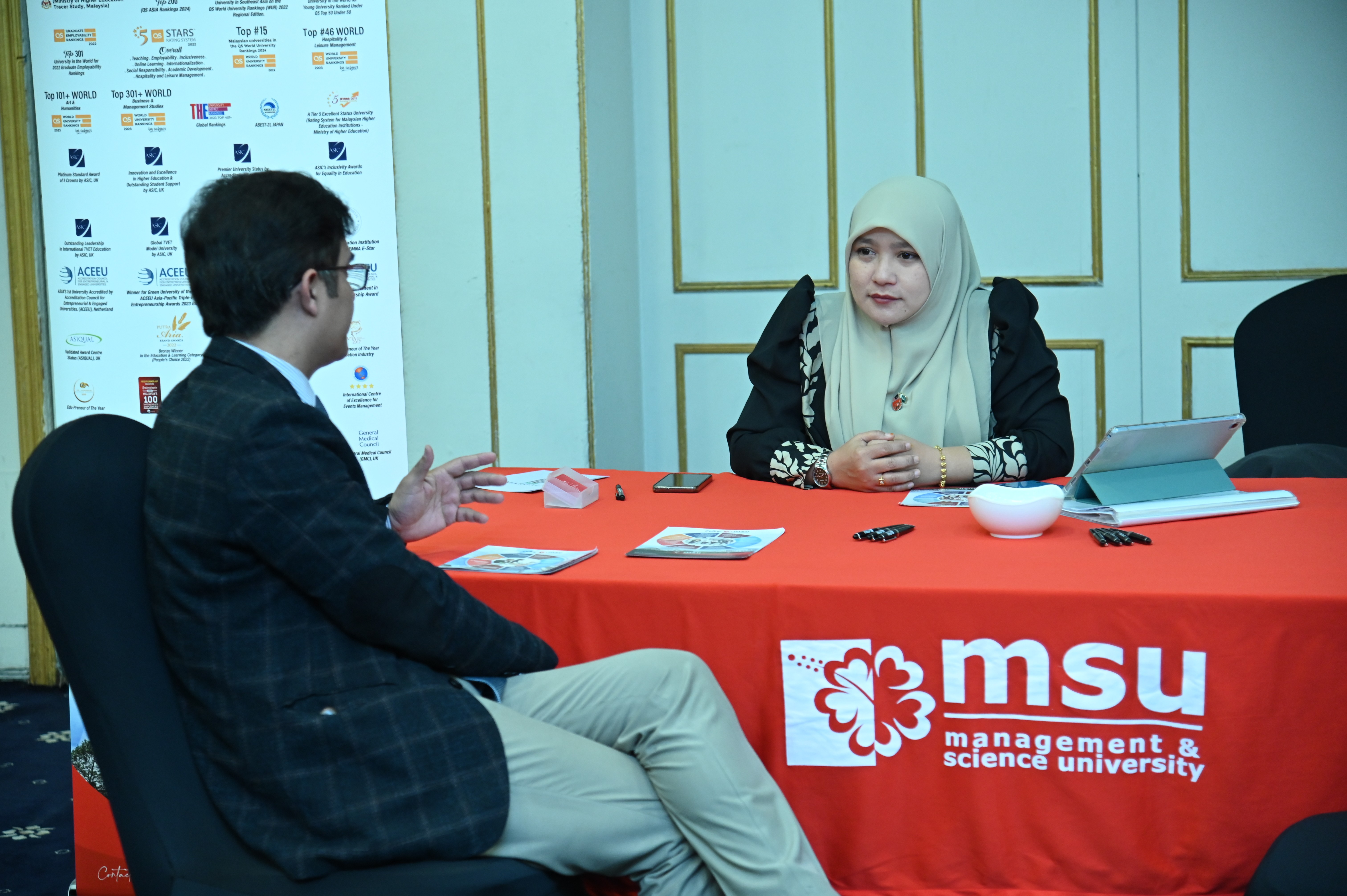 The management and science university briefing a student during the International Education Expo 2024