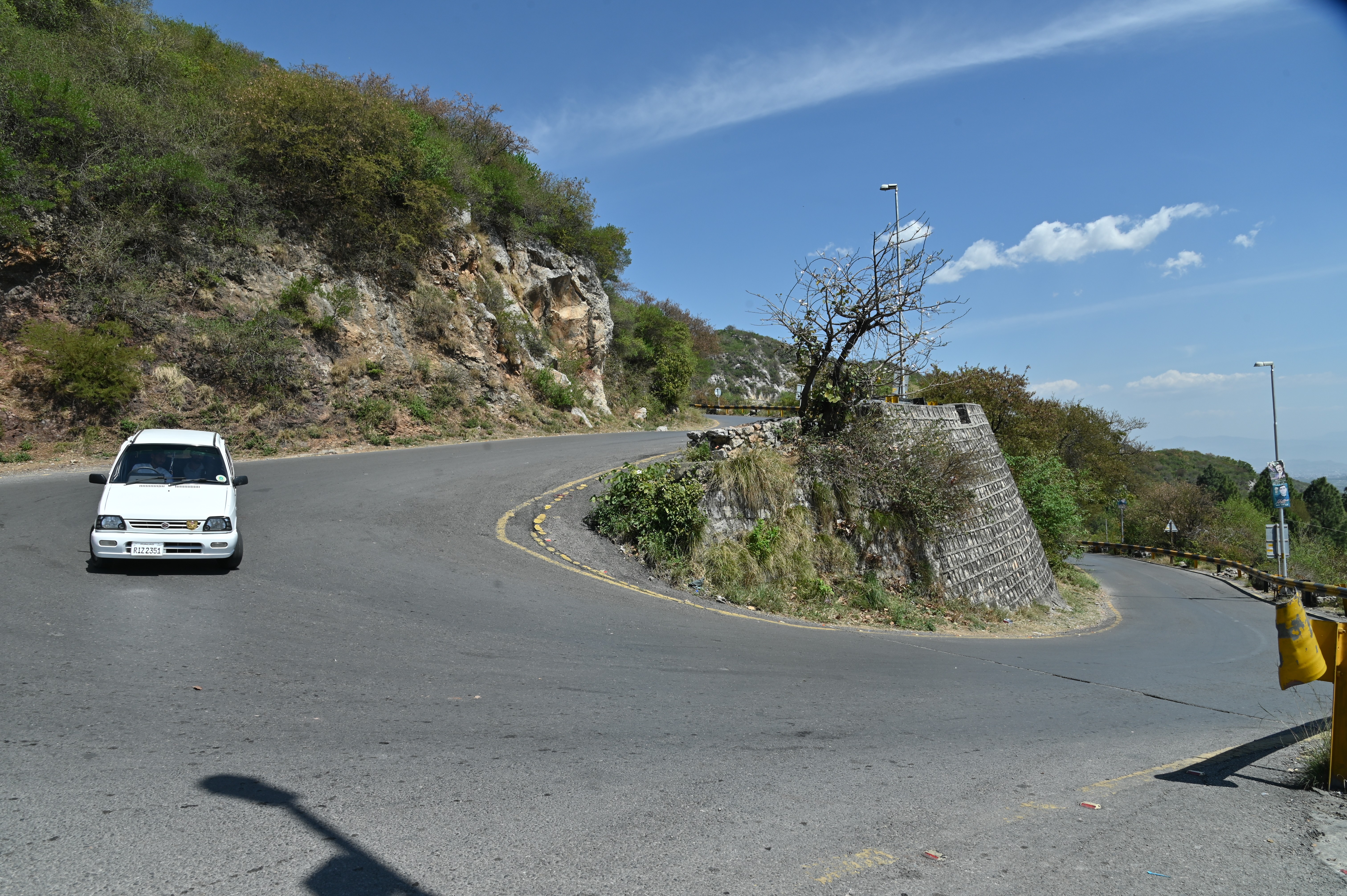 A car pasiing by the Daman-e-Koh road