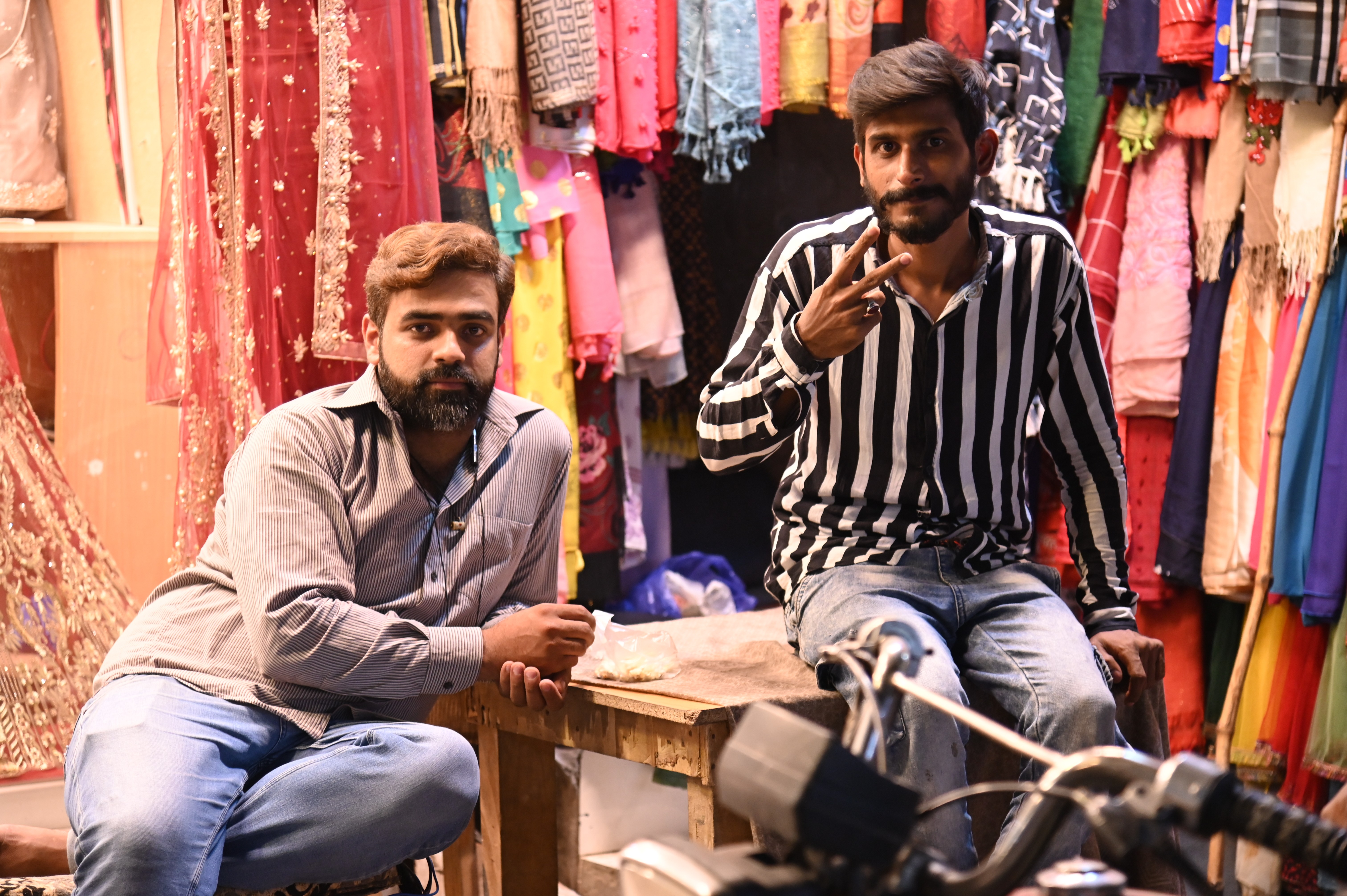 Men sitting out side the shop