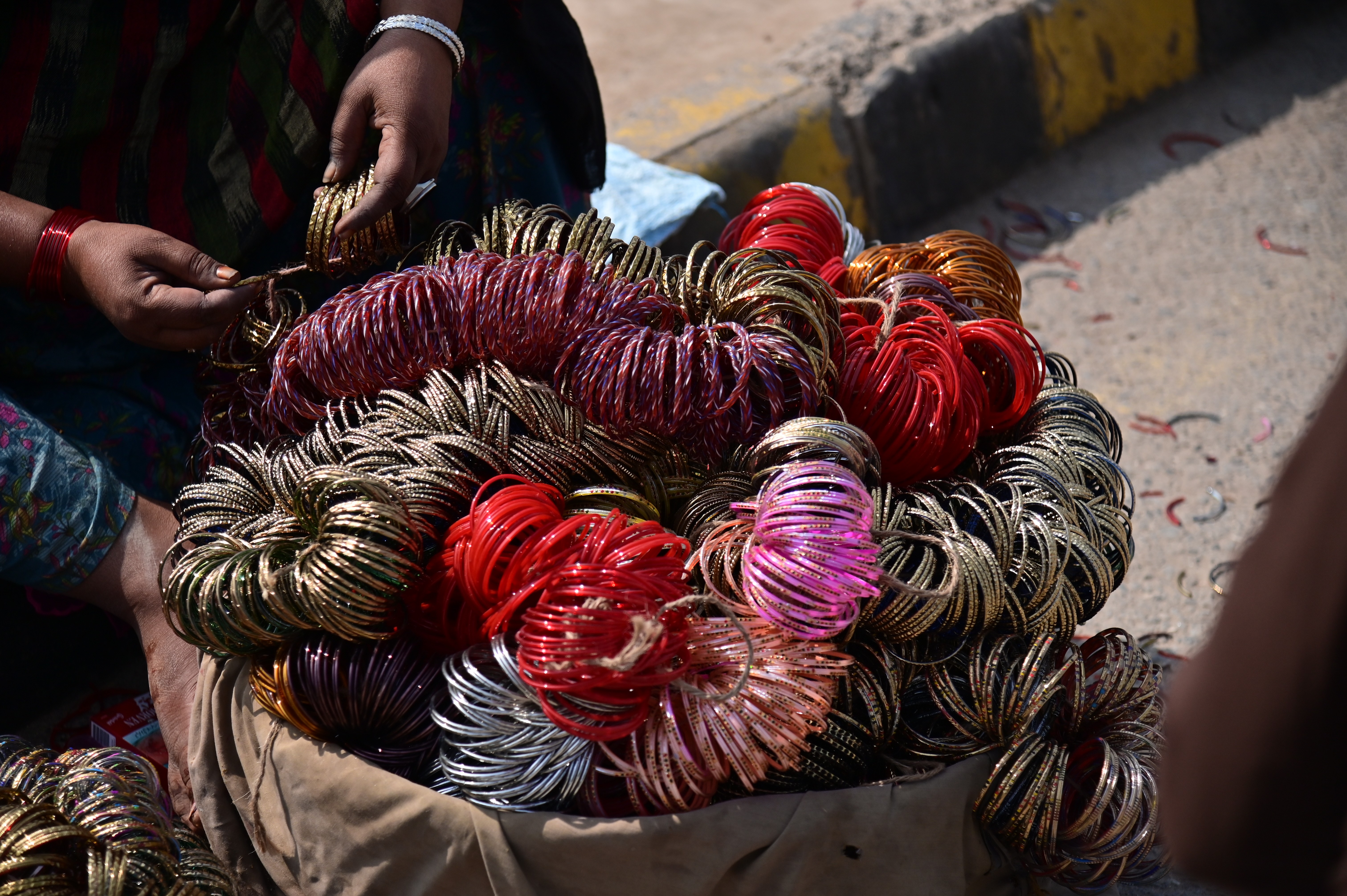 A woman selling selling colorful bangles