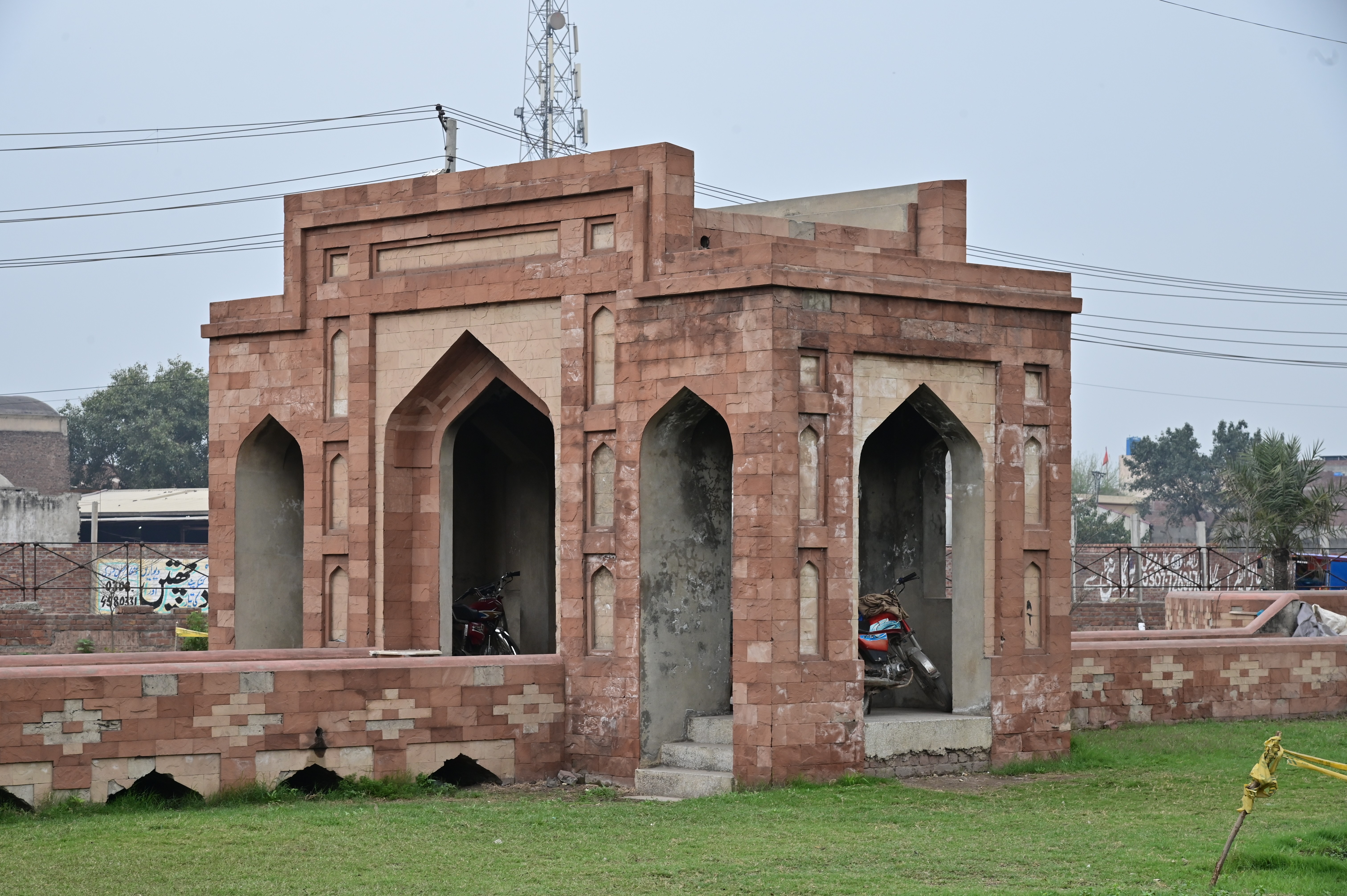 Historical red sandstone monument with intricate Mughal-era design