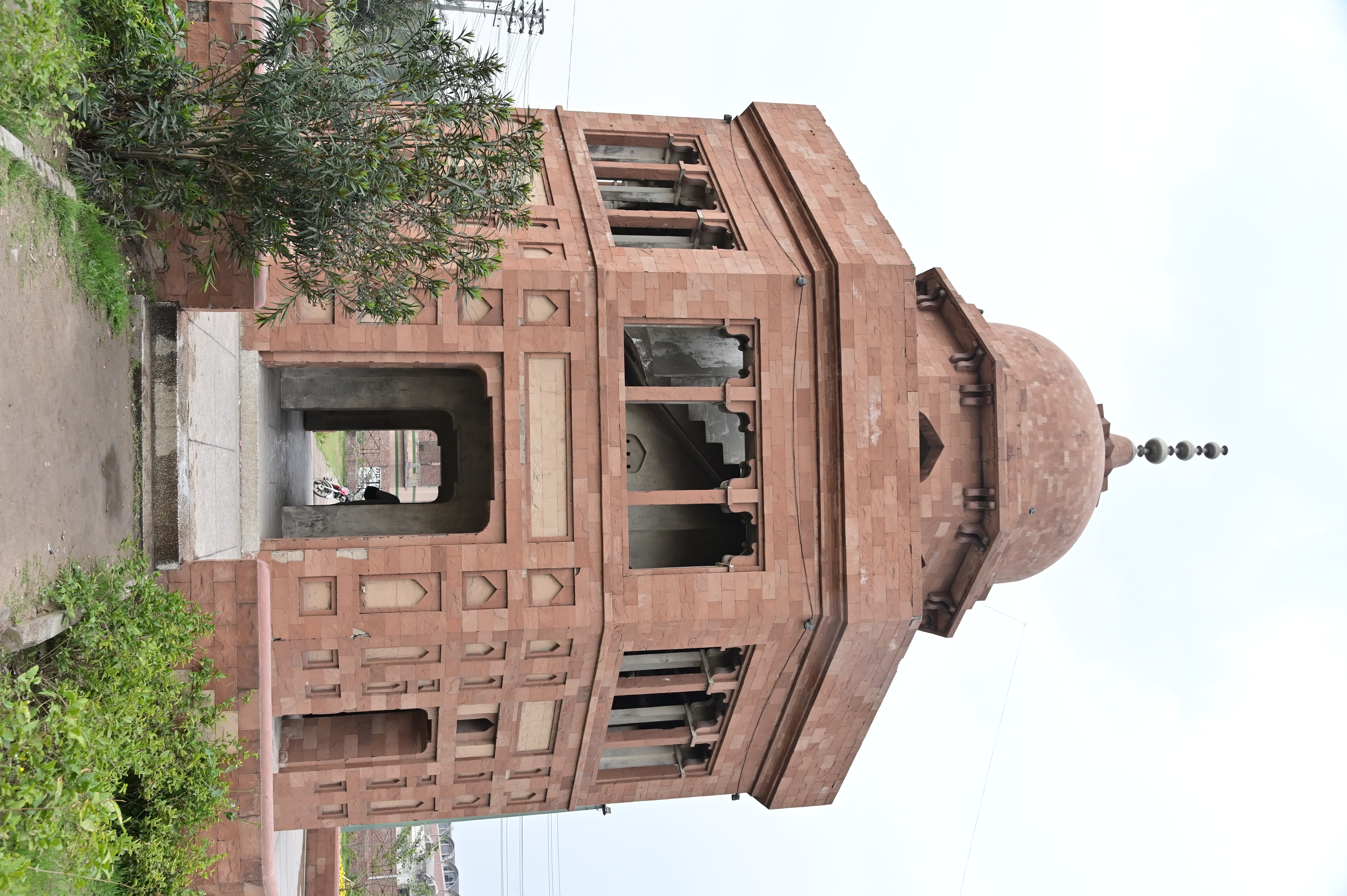 Historical red sandstone monument with intricate Mughal-era design
