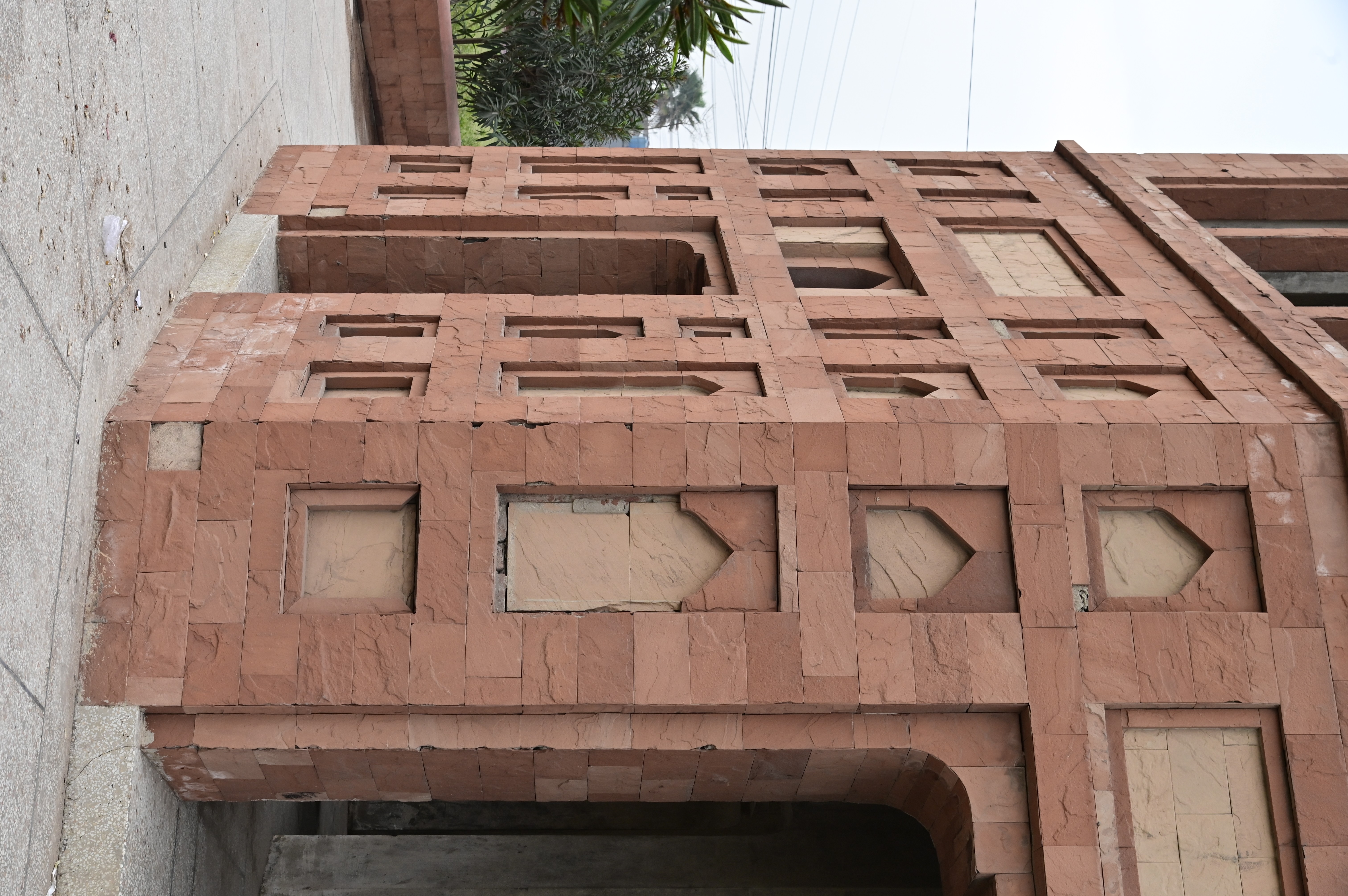 Historical red sandstone monument with intricate Mughal-era design