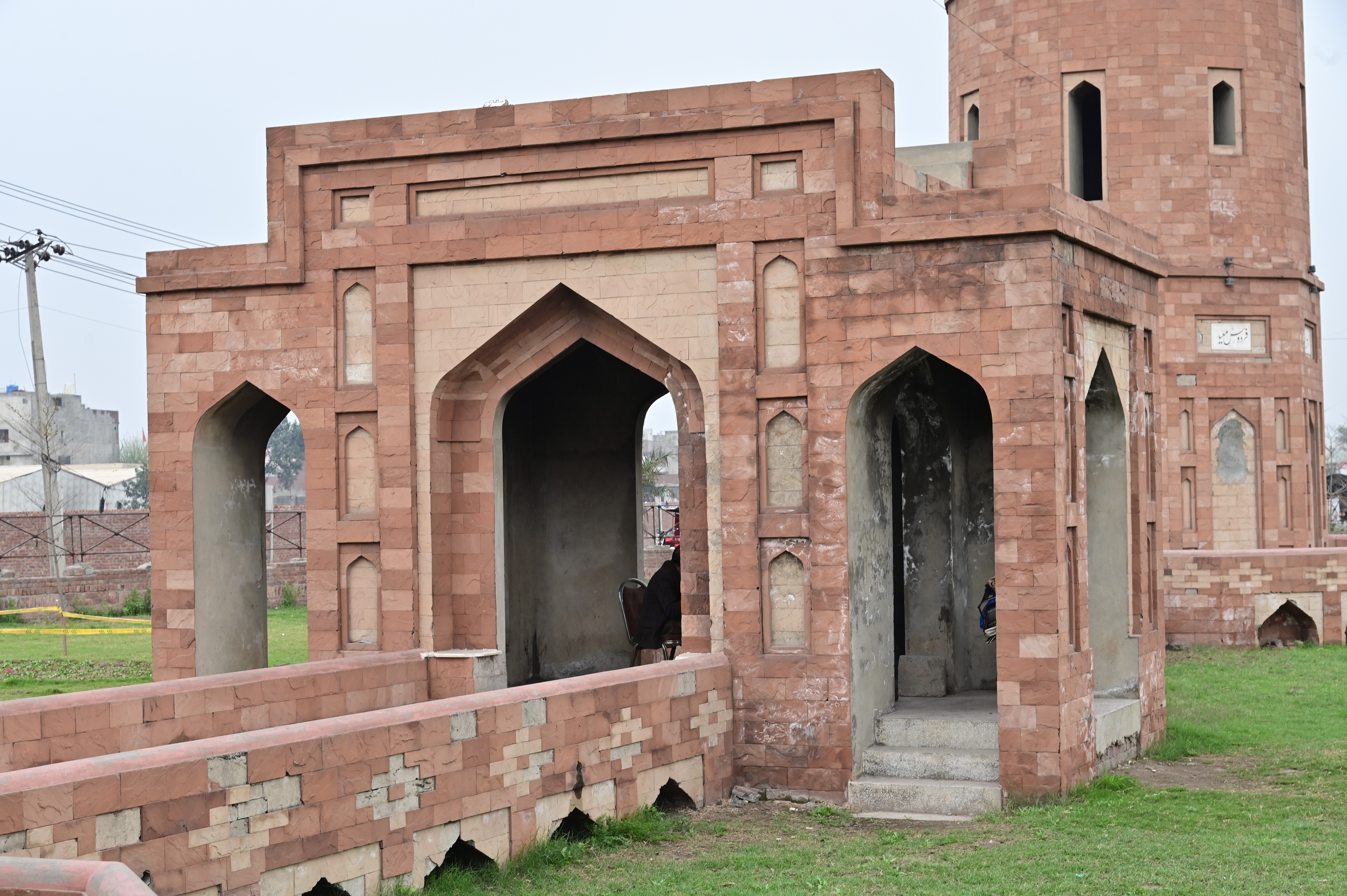 Historical red sandstone monument with intricate Mughal-era design