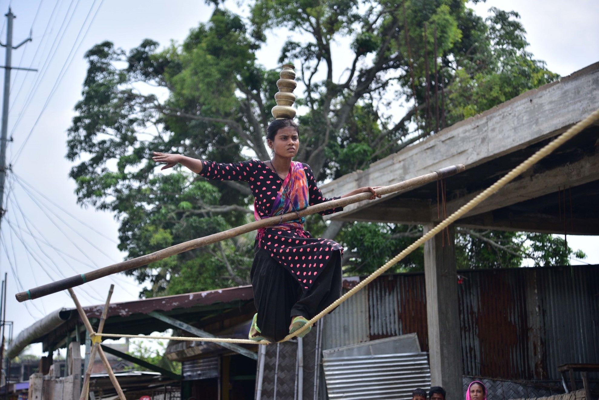 بھارت کی شمال مشرقی ریاست آسام کے ضلع ناگاؤں میں اسٹریٹ شو کے دوران ایک لڑکی رسی پر توازن برقرارر کھنے کا مظاہرہ کر رہی ہے۔(شِنہوا)